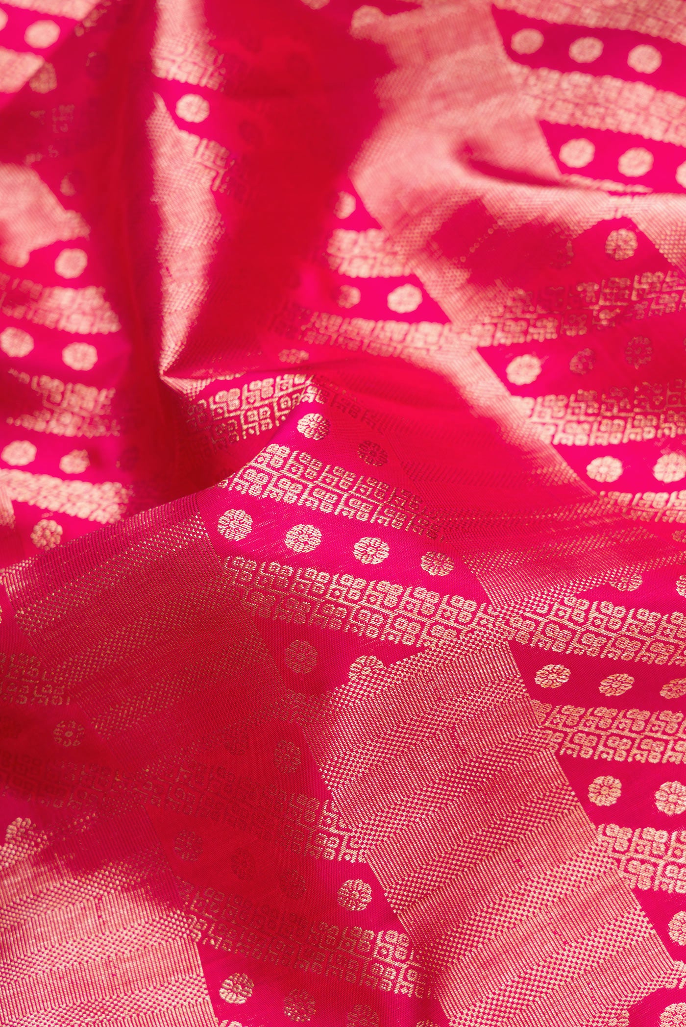 Close up of Pink Dual Tone Kanchipuram Silk Saree with Zari Brocade on the body and Zari Border.  displaying folds
