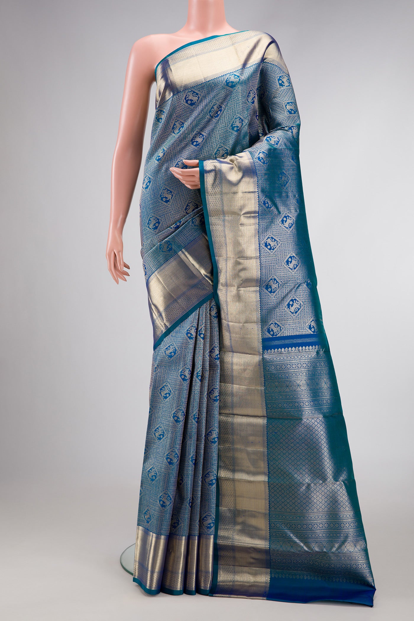 Peacock Blue Dual Tone Kanchipuram Silk Saree with Zari Brocade on the body and Zari Border.  displayed on a mannequin
