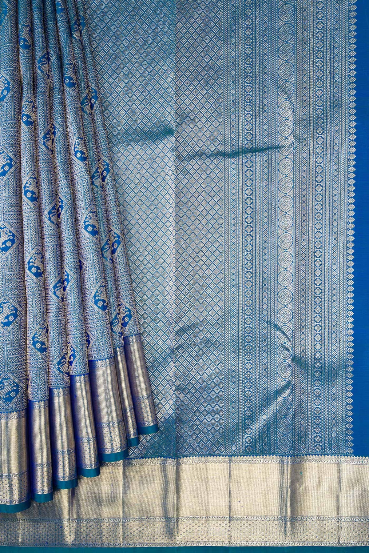 Pleats and pallu of Peacock Blue Dual Tone Kanchipuram Silk Saree with Zari Brocade on the body and Zari Border. 