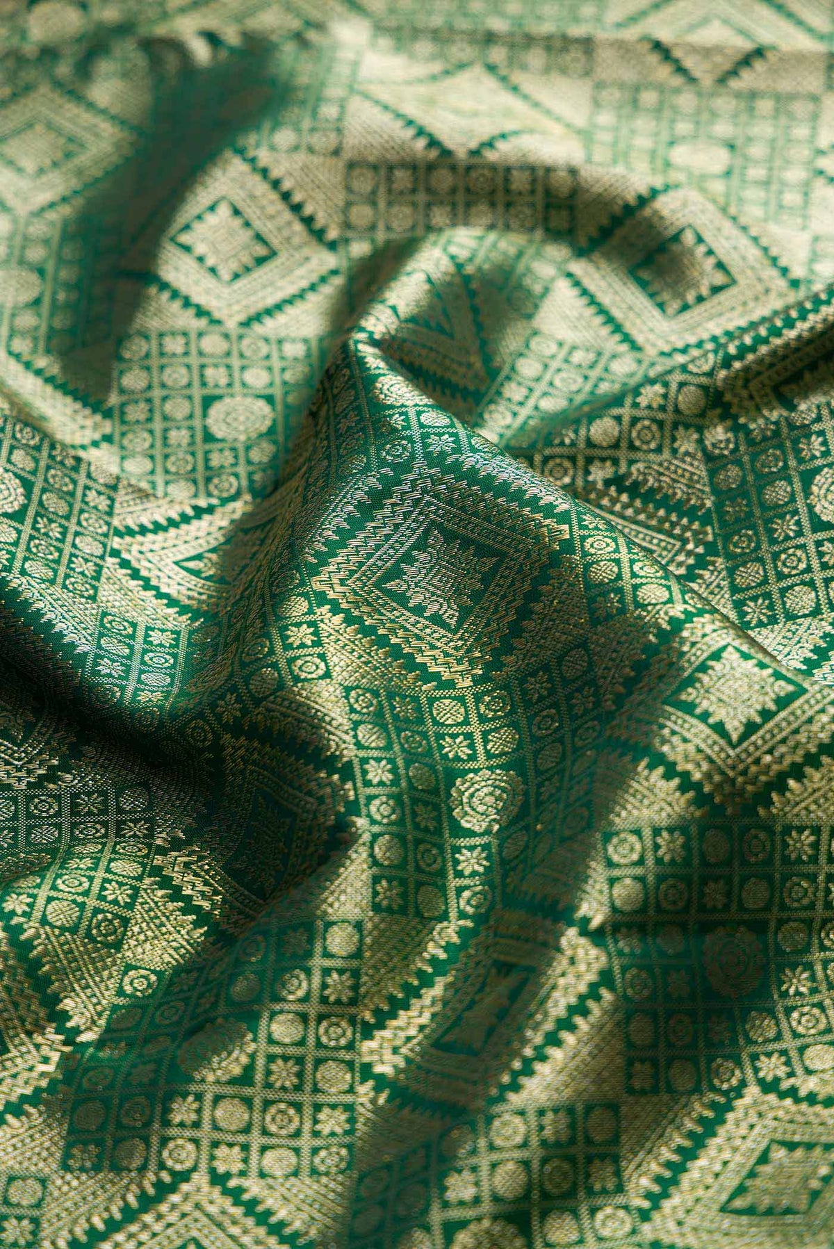 Close up of Bottle Green Dual Tone Kanchipuram Saree with Zari Brocade on the body and Zari Border displaying folds