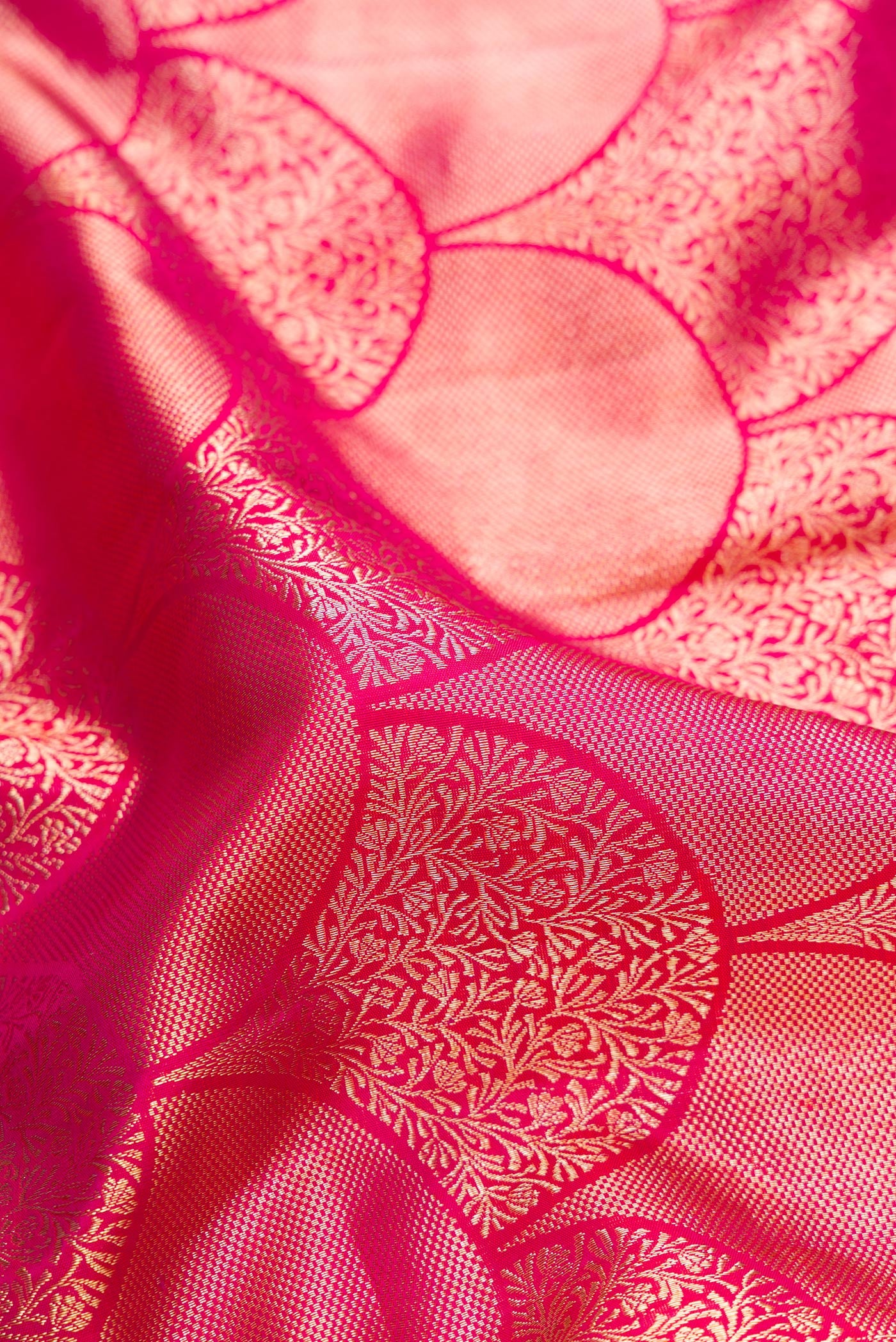 Close up of Pink Dual Tone Kanchipuram Silk Saree with Zari Brocade on the body and Zari Border.  displaying folds