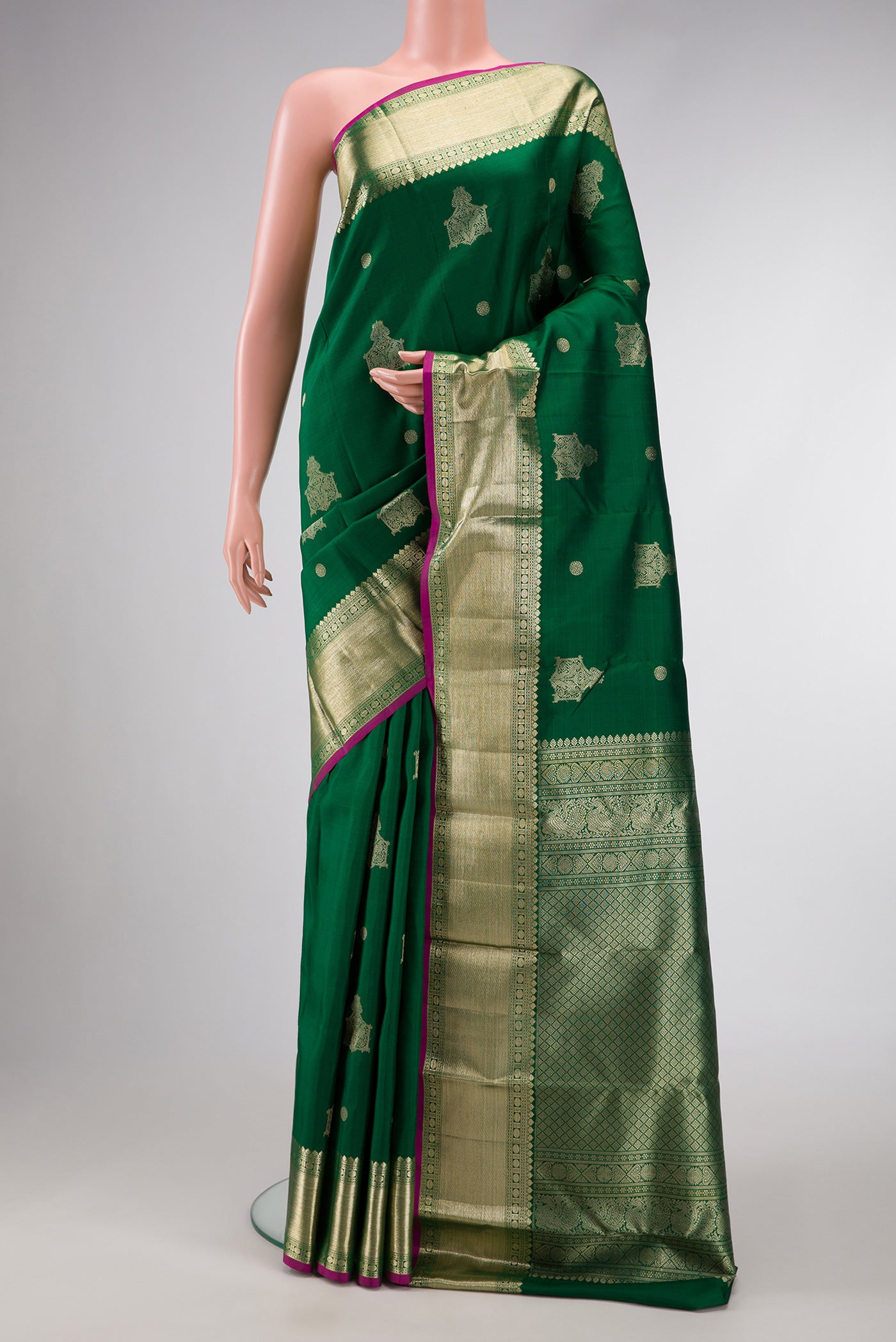 Green Dual Tone Kanjivaram Silk Saree with Zari Butta on the body and Zari Border.  displayed on a mannequin