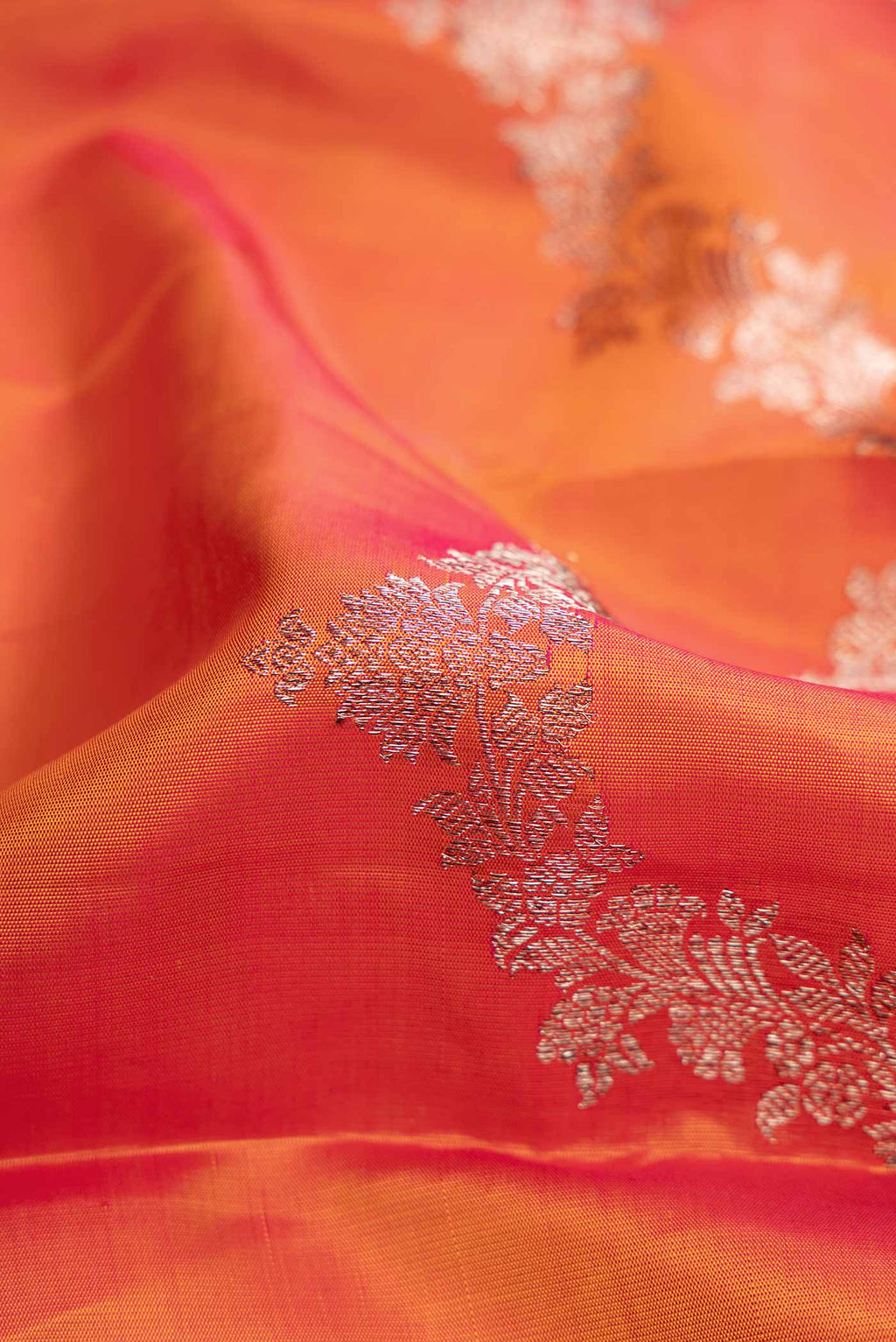 Close up of Coral Dual Tone Kanchipuram Silk Saree with Zari Brocade on the body and Without Border displaying folds