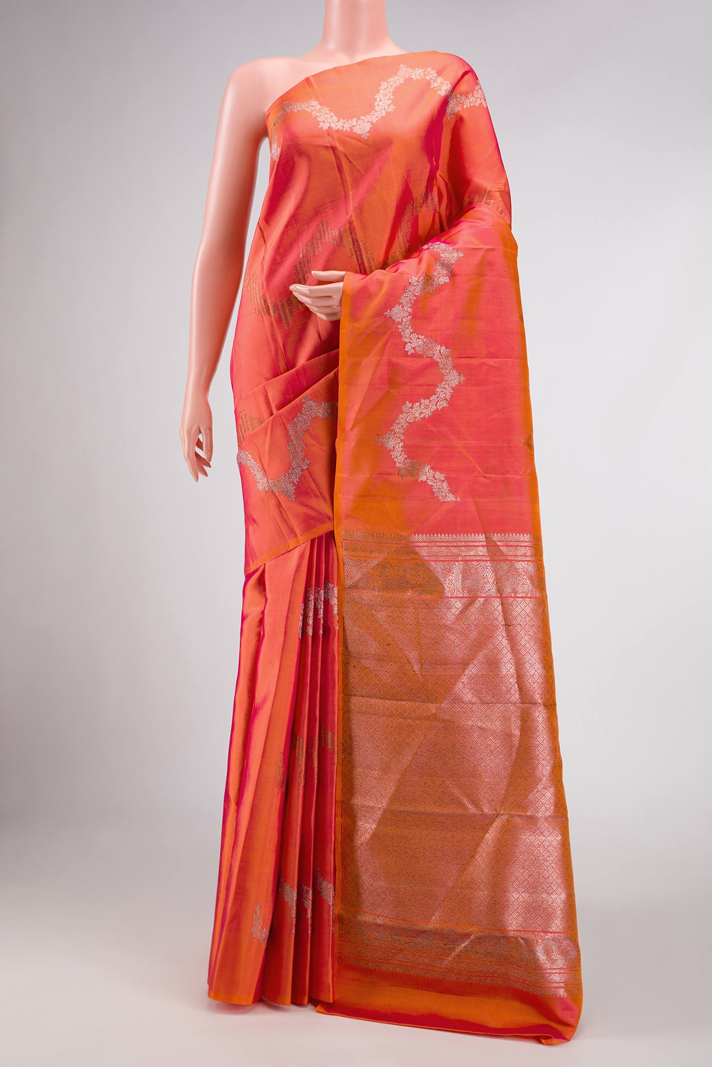 Coral Dual Tone Kanchipuram Silk Saree with Zari Brocade on the body and Without Border displayed on a mannequin