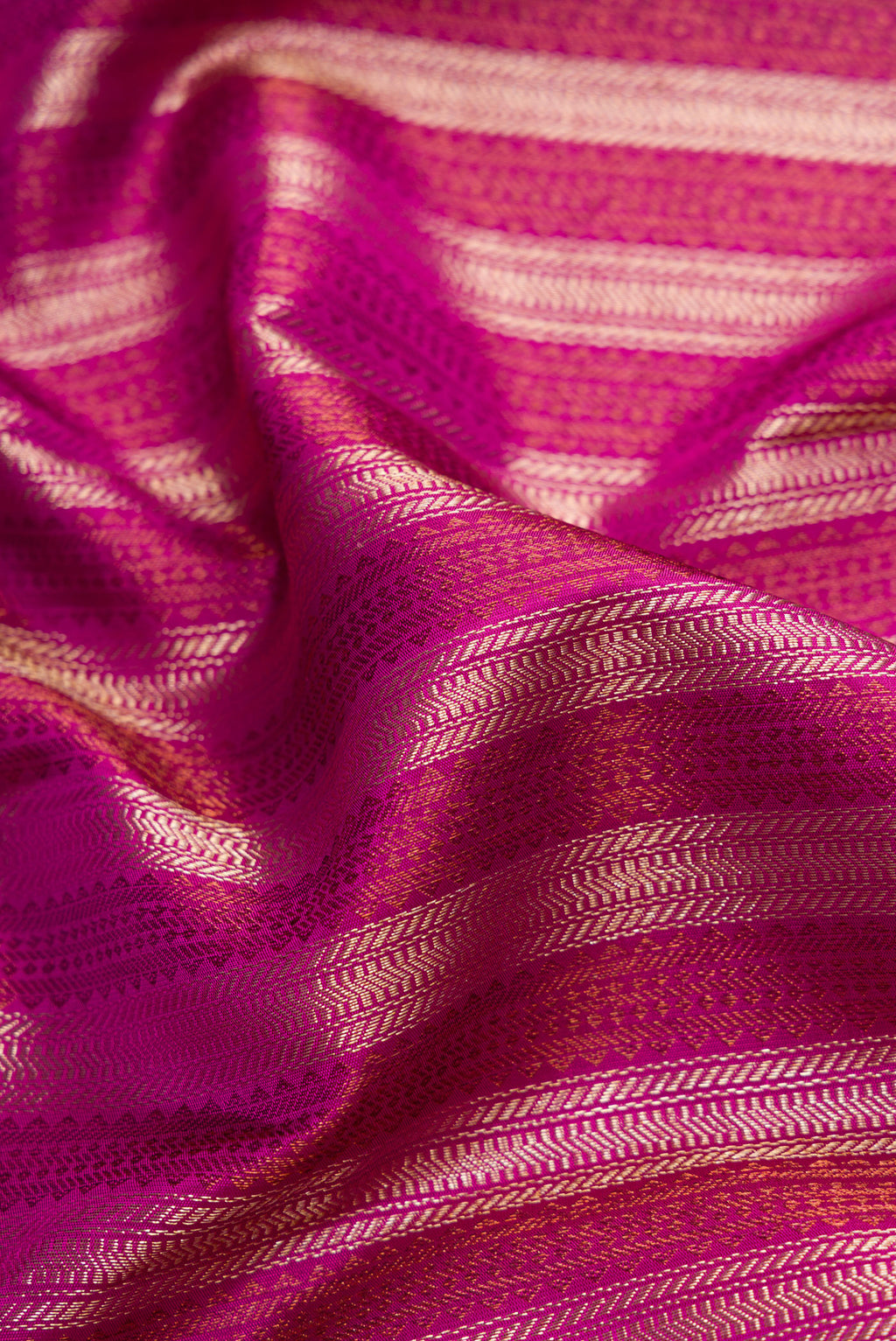 Close up of Magenta Dual Tone Kanjivaram Silk Saree with Zari Brocade on the body and Fancy Border.  displaying folds