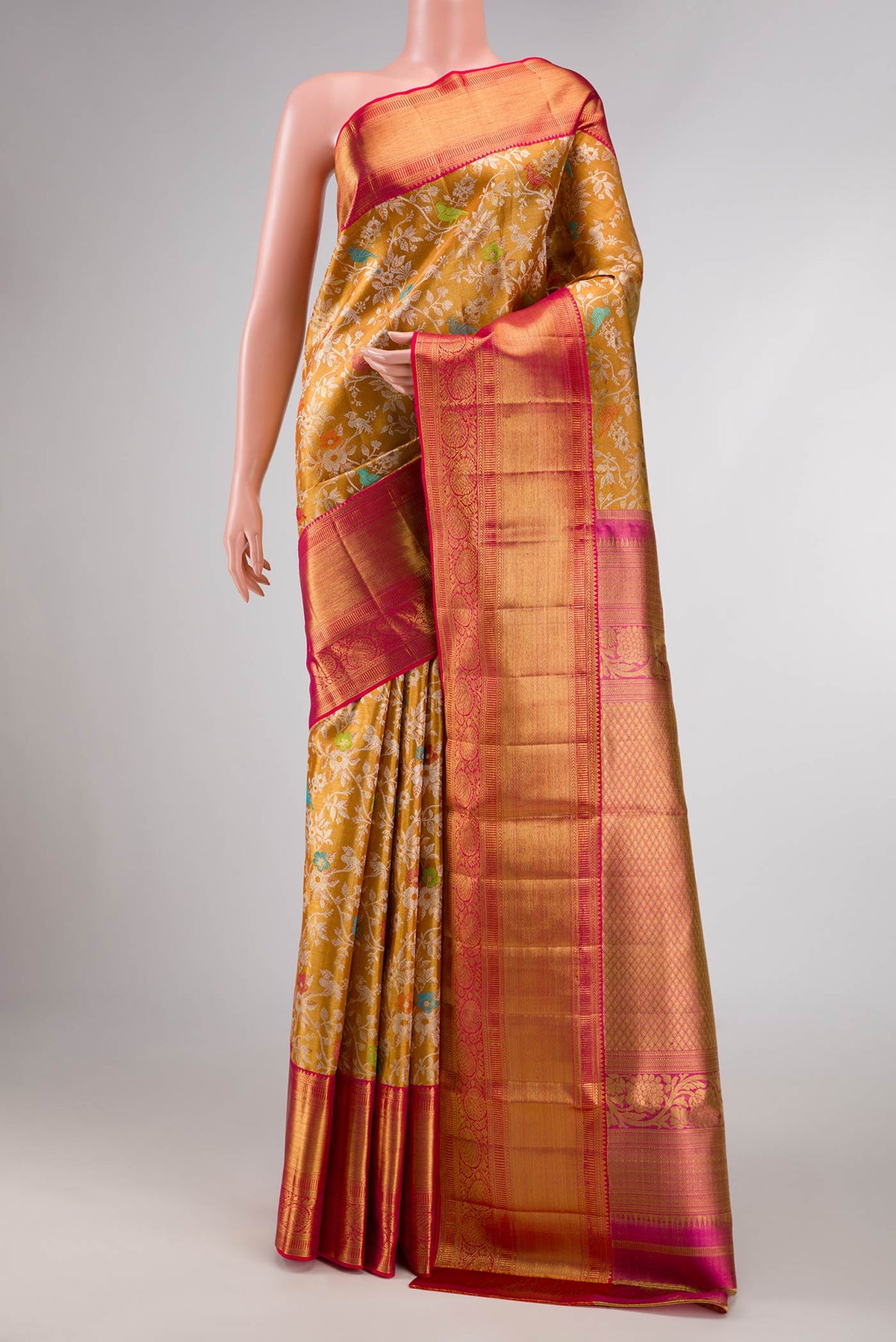 Gold Dual Tone Kanchipuram Silk Saree with Zari Brocade on the body and Zari Border displayed on a mannequin
