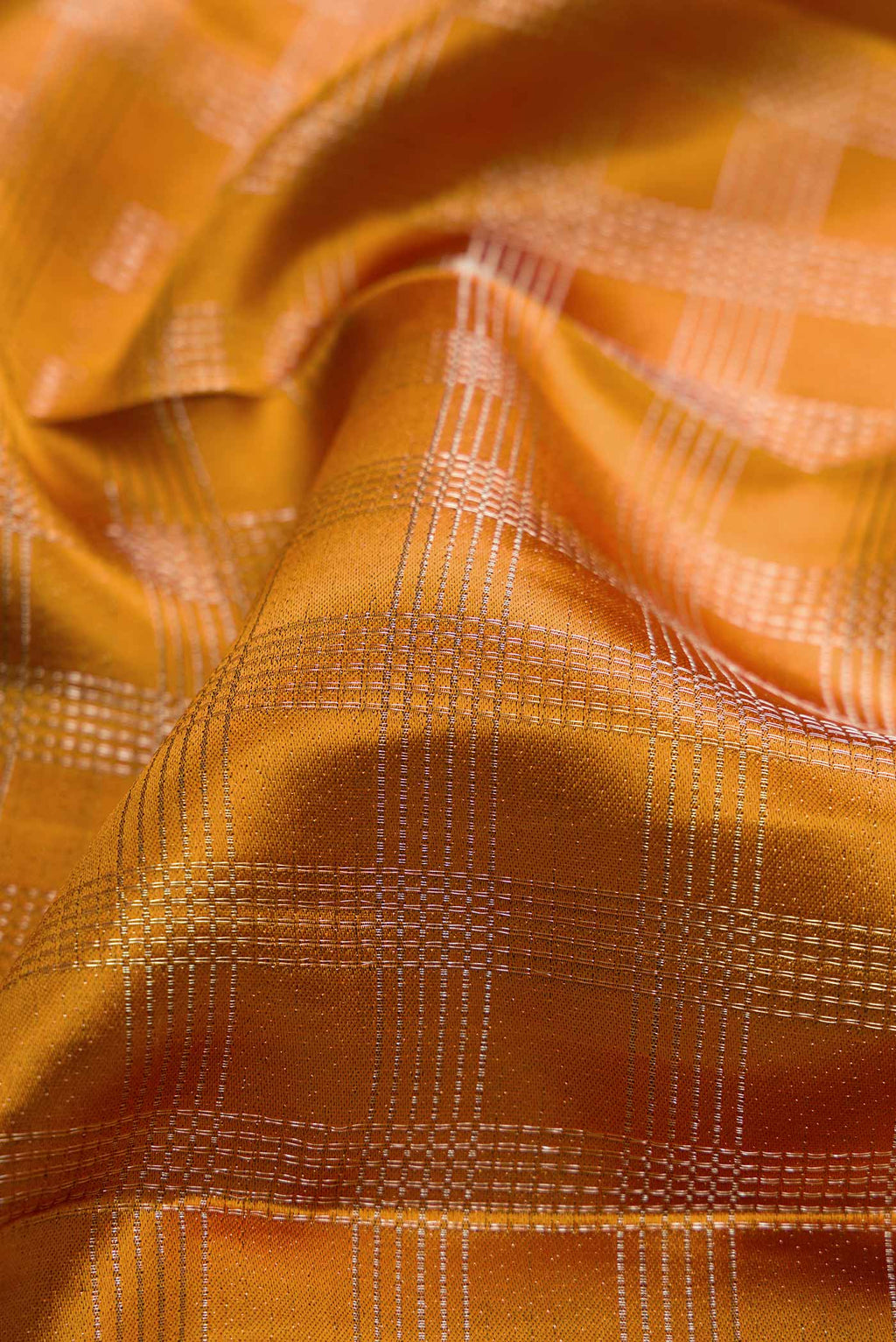 Close up of Mustard Dual Tone Kanchipuram Silk Saree with Zari Brocade on the body and Zari Border displaying folds