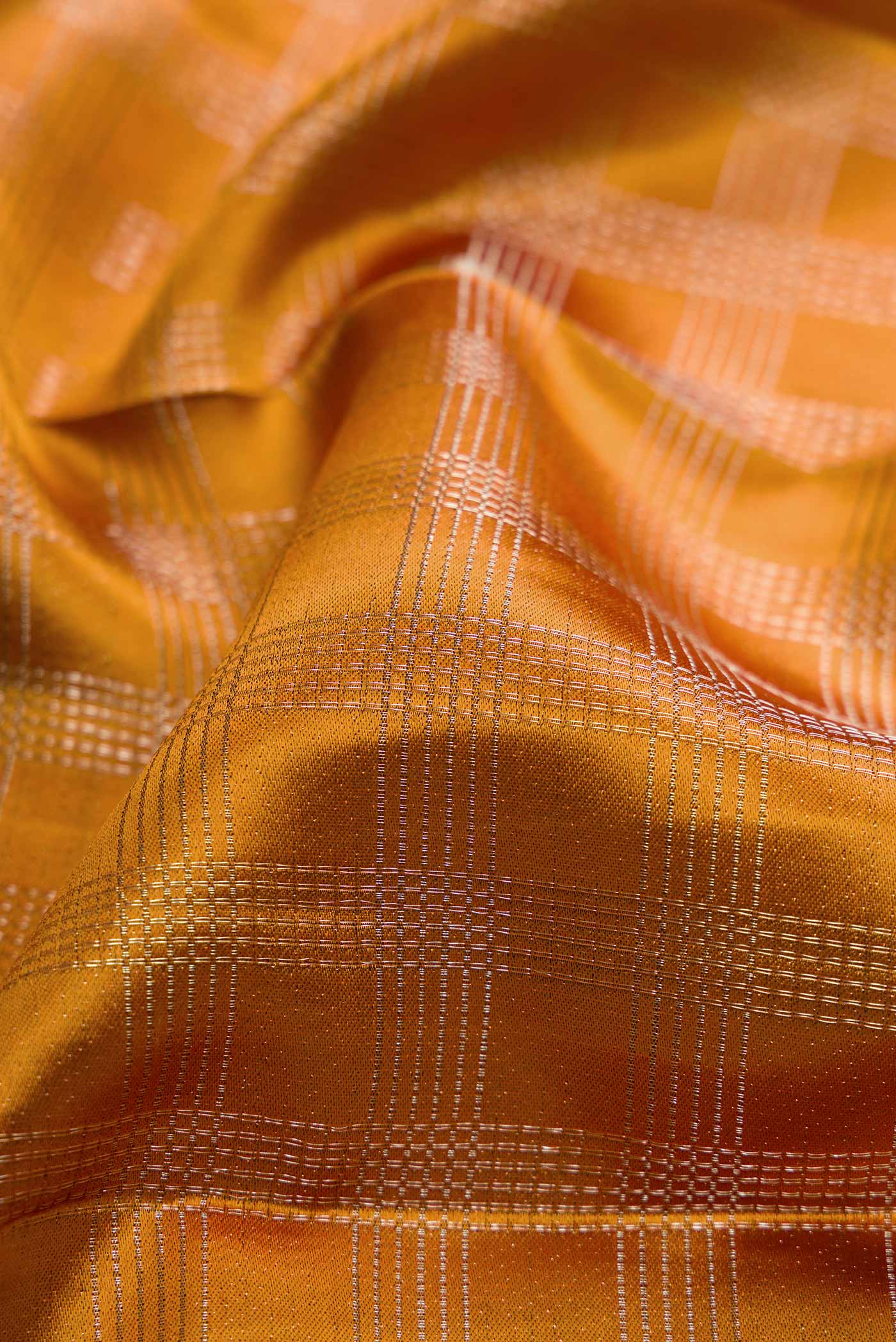 Close up of Mustard Dual Tone Kanchipuram Silk Saree with Zari Brocade on the body and Zari Border displaying folds