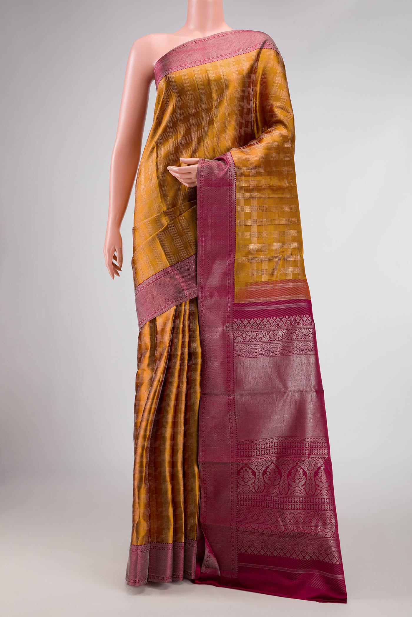 Mustard Dual Tone Kanchipuram Silk Saree with Zari Brocade on the body and Zari Border displayed on a mannequin