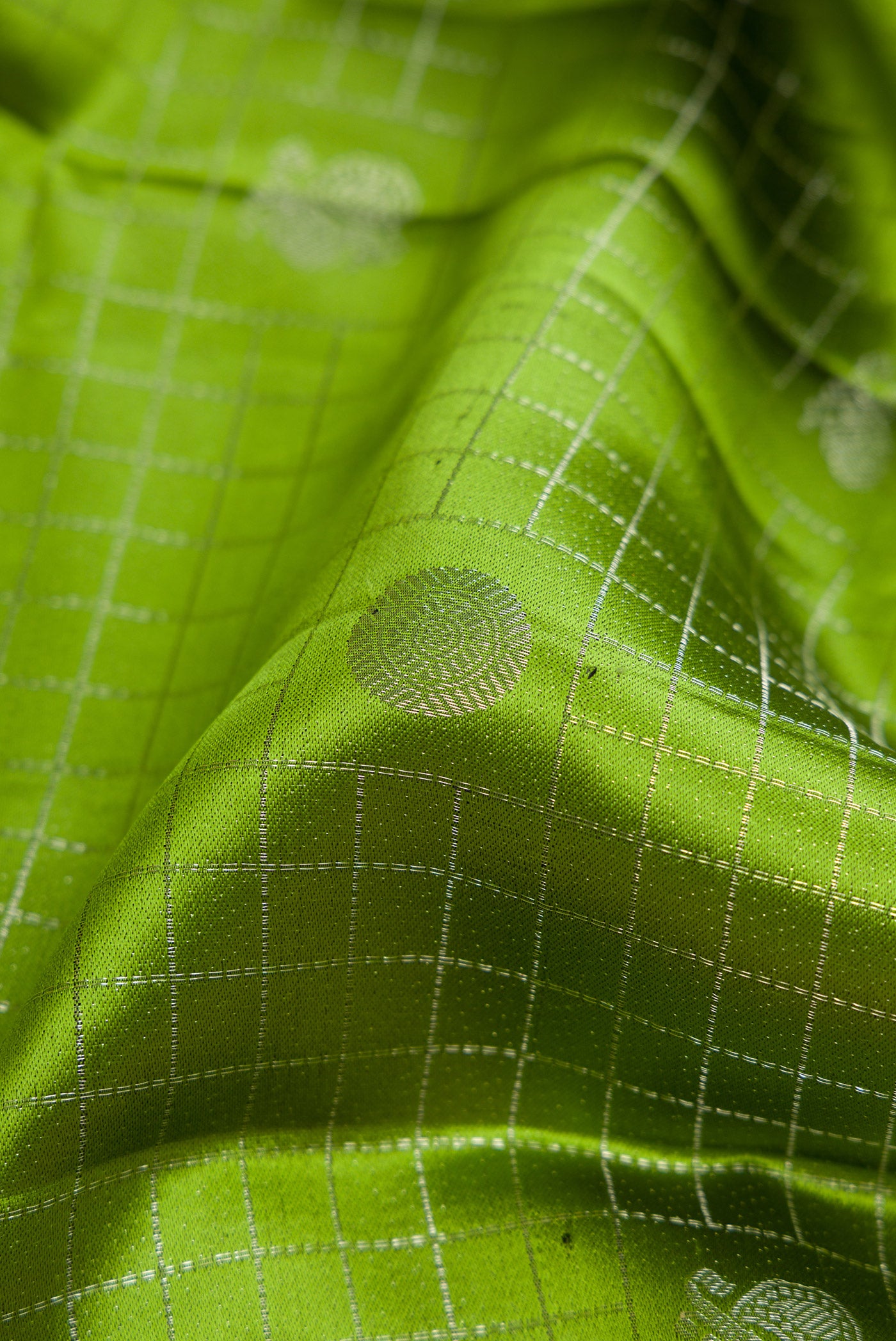 Close up of Mehandi Green Dual Tone Kanjivaram Silk Saree with Zari Brocade on the body and Zari Border.  displaying folds