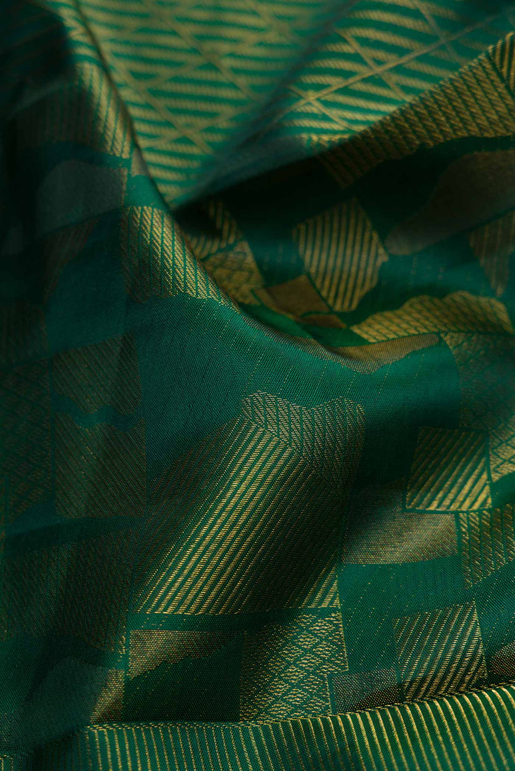 Close up of Bottle Green Dual Tone Kanjivaram Silk Saree with Zari Brocade on the body and Zari Border.  displaying folds
