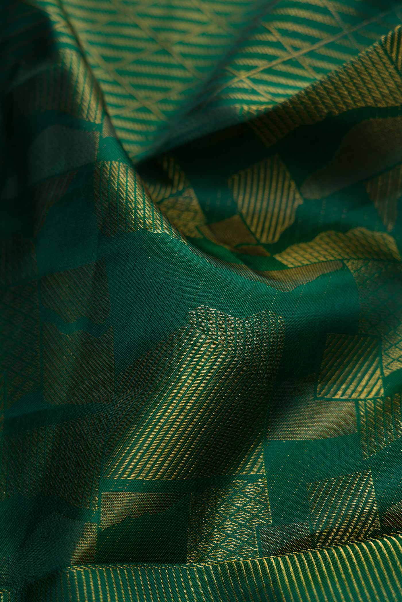 Close up of Bottle Green Dual Tone Kanjivaram Silk Saree with Zari Brocade on the body and Zari Border.  displaying folds