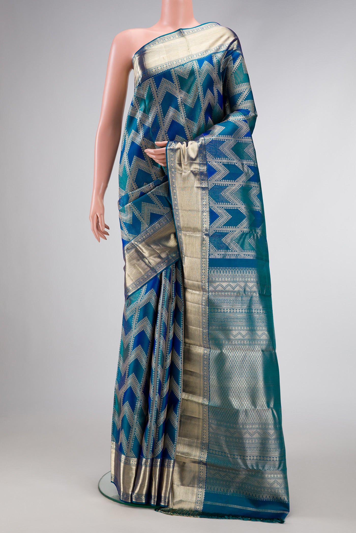 Peacock Blue Dual Tone Kanjivaram Silk Saree with Zari Brocade on the body and Zari Border.  displayed on a mannequin
