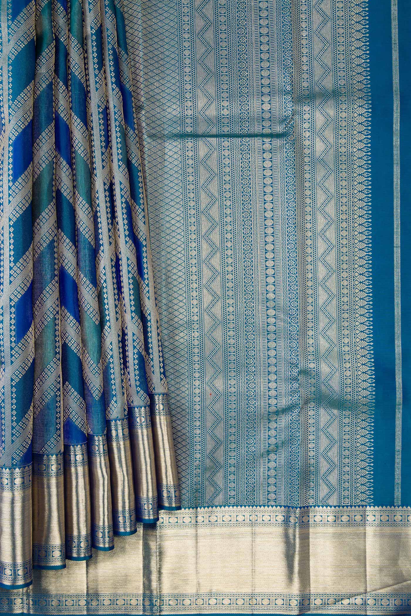 Pleats and pallu of Peacock Blue Dual Tone Kanjivaram Silk Saree with Zari Brocade on the body and Zari Border. 