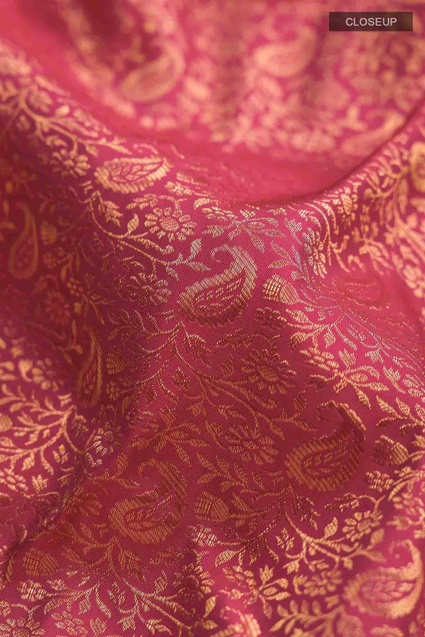 Close up of Pink Kanchipuram Silk Saree with Zari Brocade on the body and Zari Border displaying folds