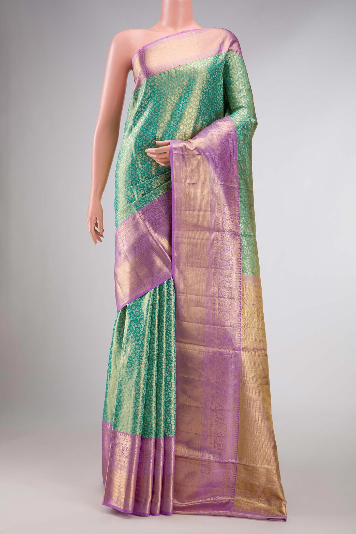 Green Dual Tone Kanchipuram Tissue Silk Saree with Zari Brocade on the body and Zari Border displayed on a mannequin