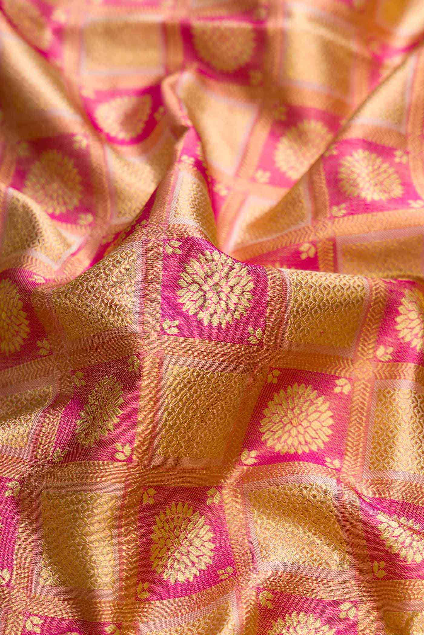 Close up of Pink Dual Tone Kanchipuram Tissue Silk Saree with Zari Brocade on the body and Zari Border displaying folds