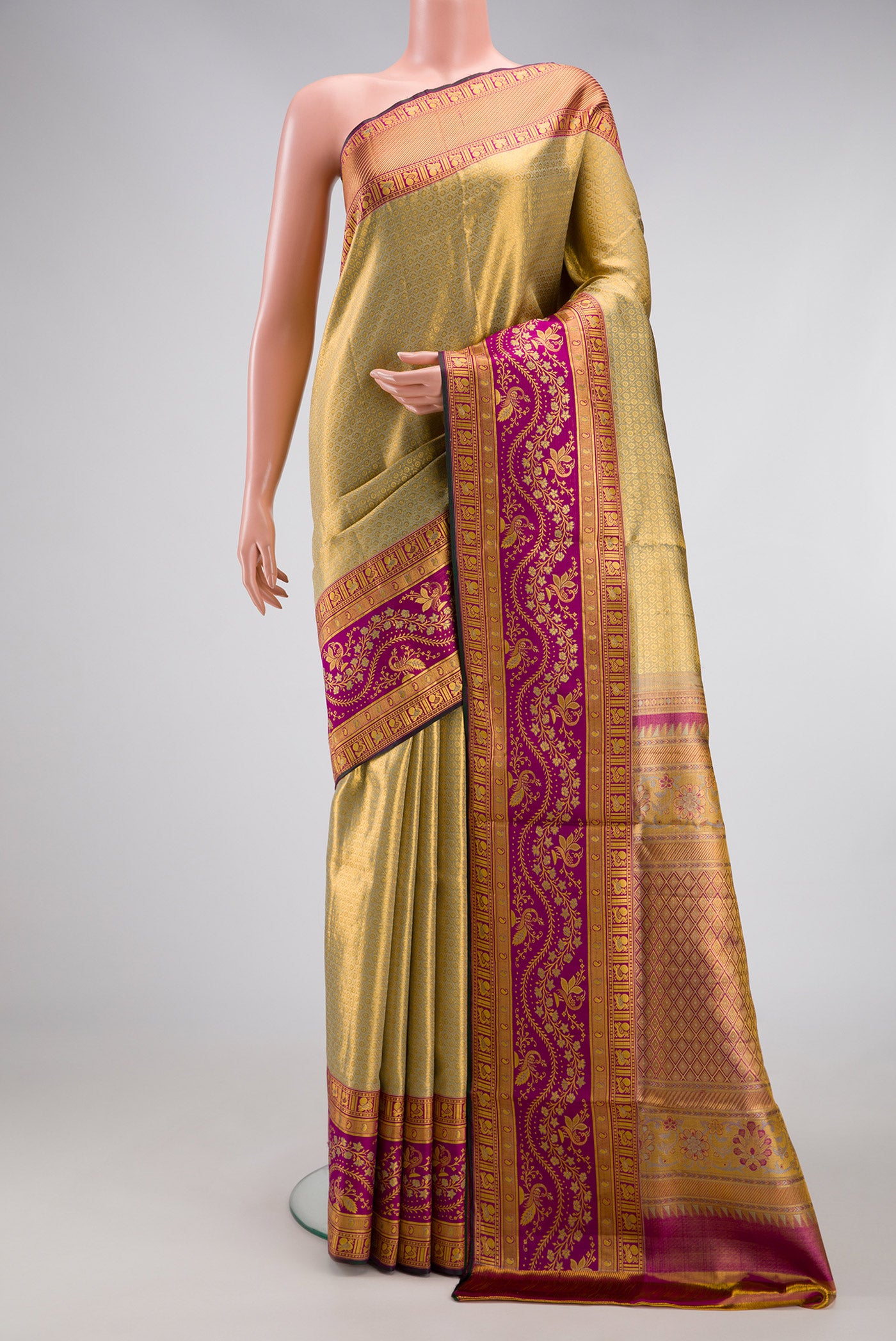 Gold Dual Tone Kanchipuram Tissue Silk Saree with Zari Brocade on the body and Zari Border.  displayed on a mannequin