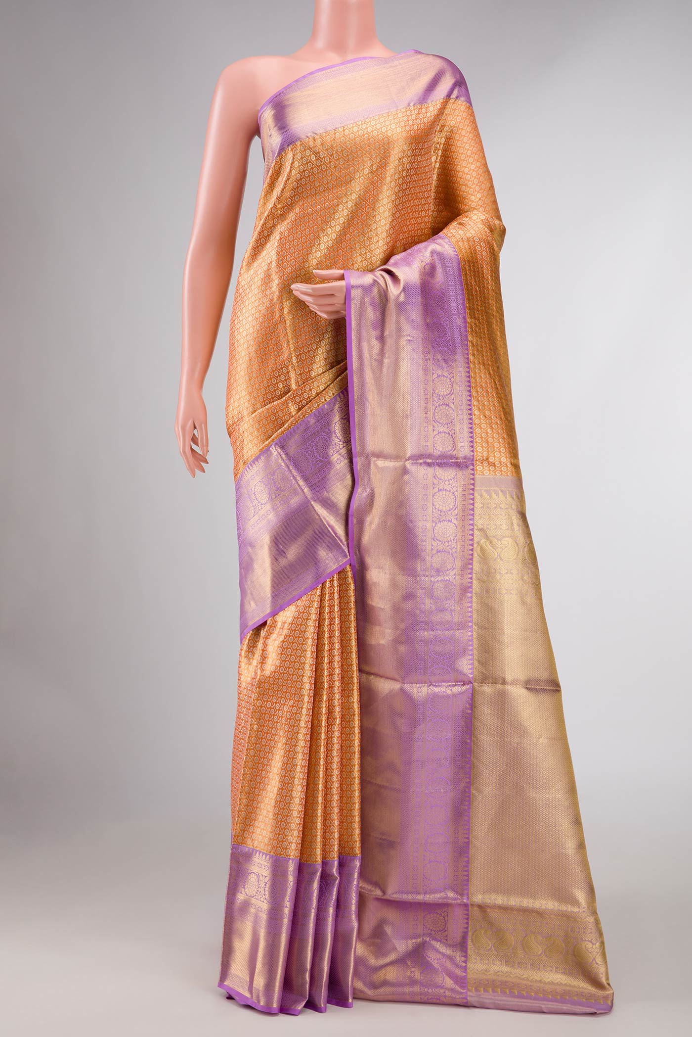 Orange Kanchipuram Tissue Silk Saree with Zari Brocade on the body and Zari Border displayed on a mannequin