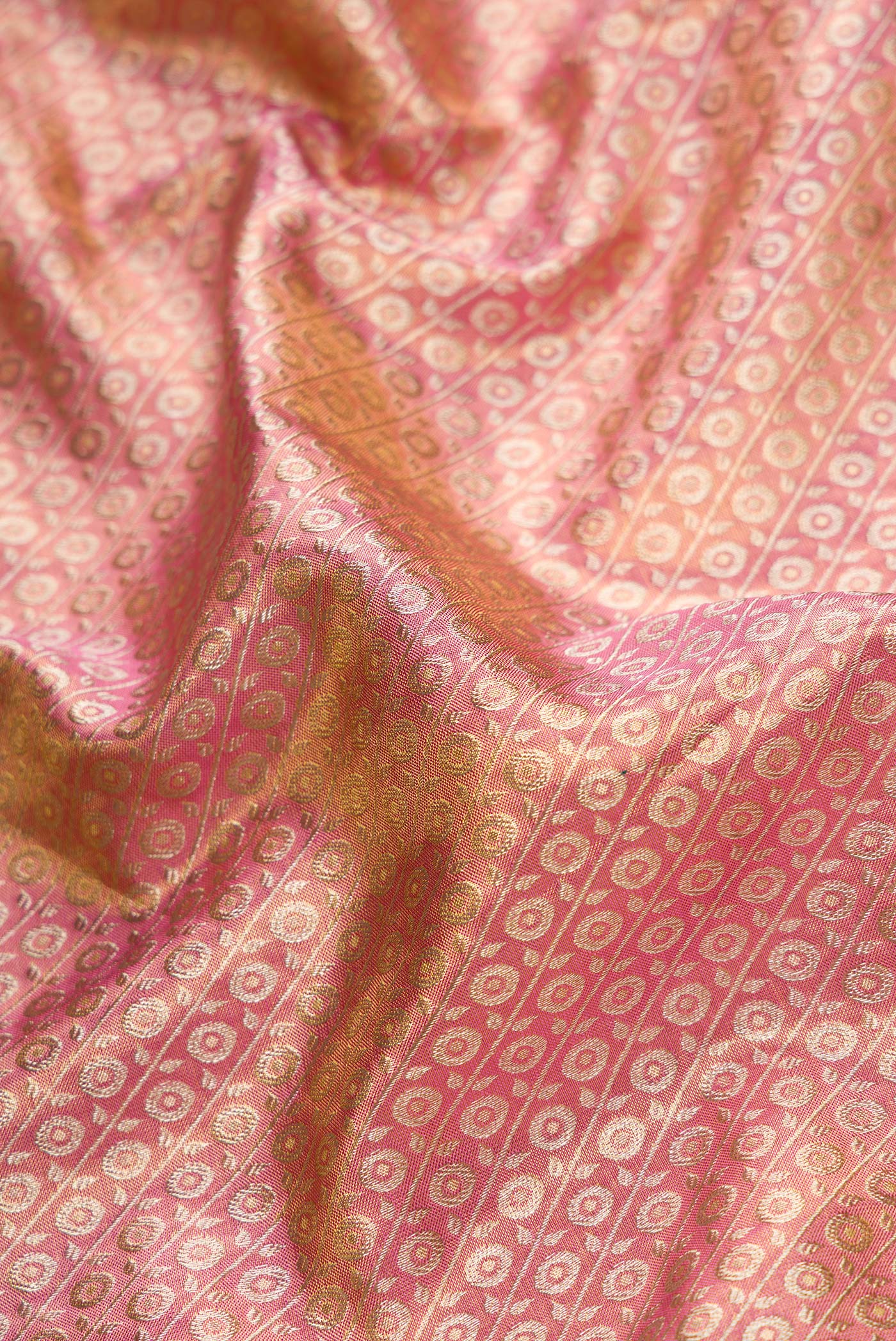 Close up of Pink Dual Tone Kanchipuram Tissue Silk Saree with Zari Brocade on the body and Zari Border.  displaying folds
