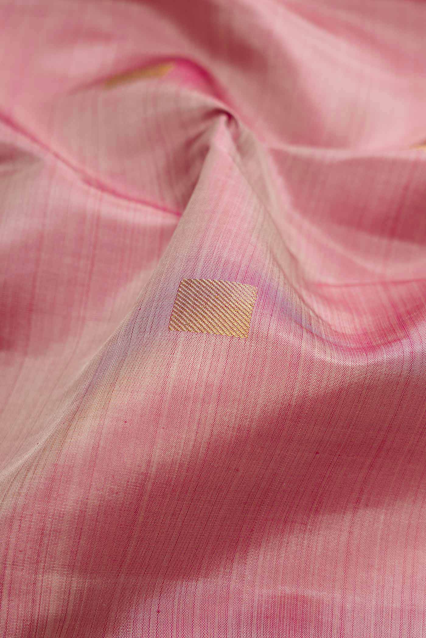 Close up of Dark Beige Dual Tone Kanjivaram Silk Saree with Zari Butta on the body and Zari Border.  displaying folds