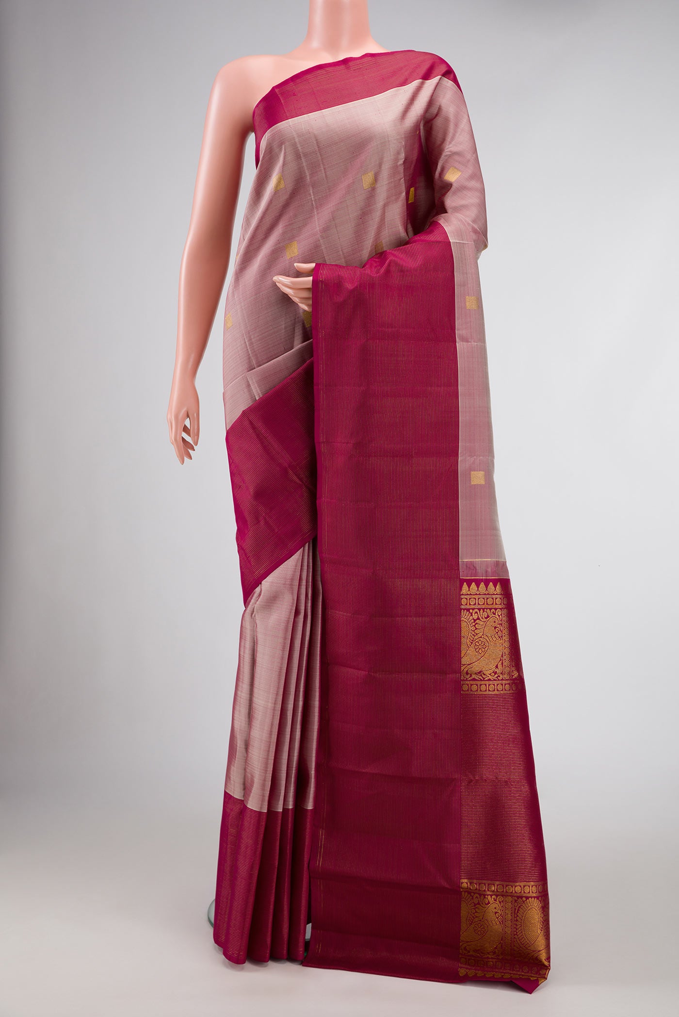 Dark Beige Dual Tone Kanjivaram Silk Saree with Zari Butta on the body and Zari Border.  displayed on a mannequin