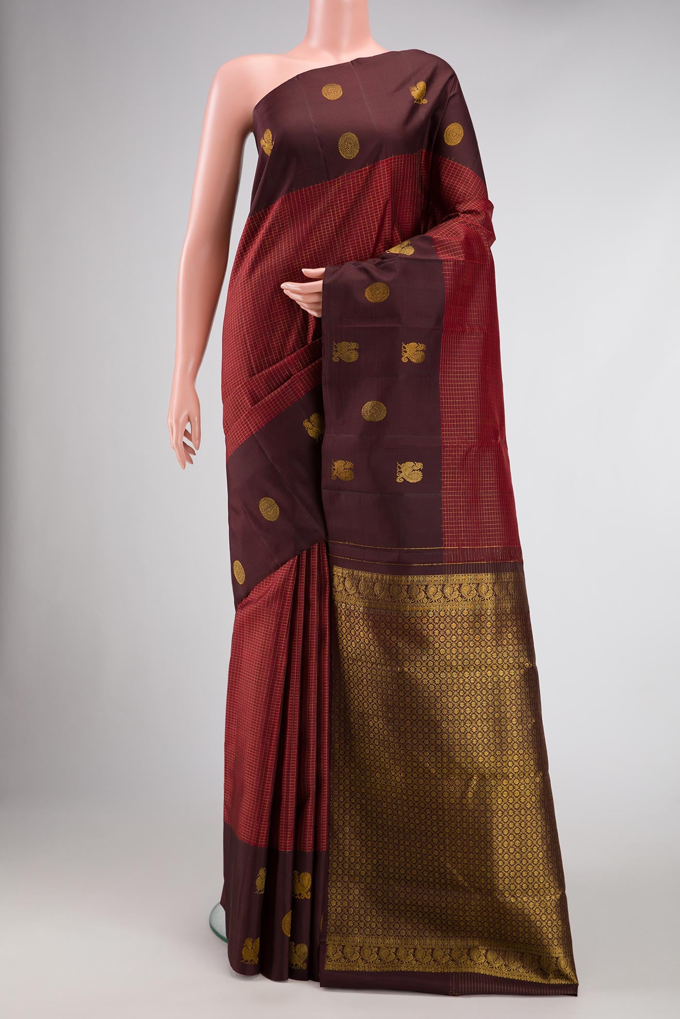 Maroon Dual Tone Kanjivaram Silk Saree with Checked design on the body and Fancy Border.  displayed on a mannequin