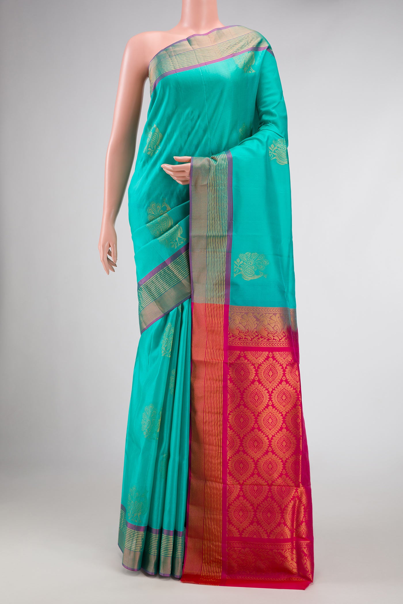 Sea Green Dual Tone Soft Silk Saree with Zari Butta on the body and Zari Border.  displayed on a mannequin