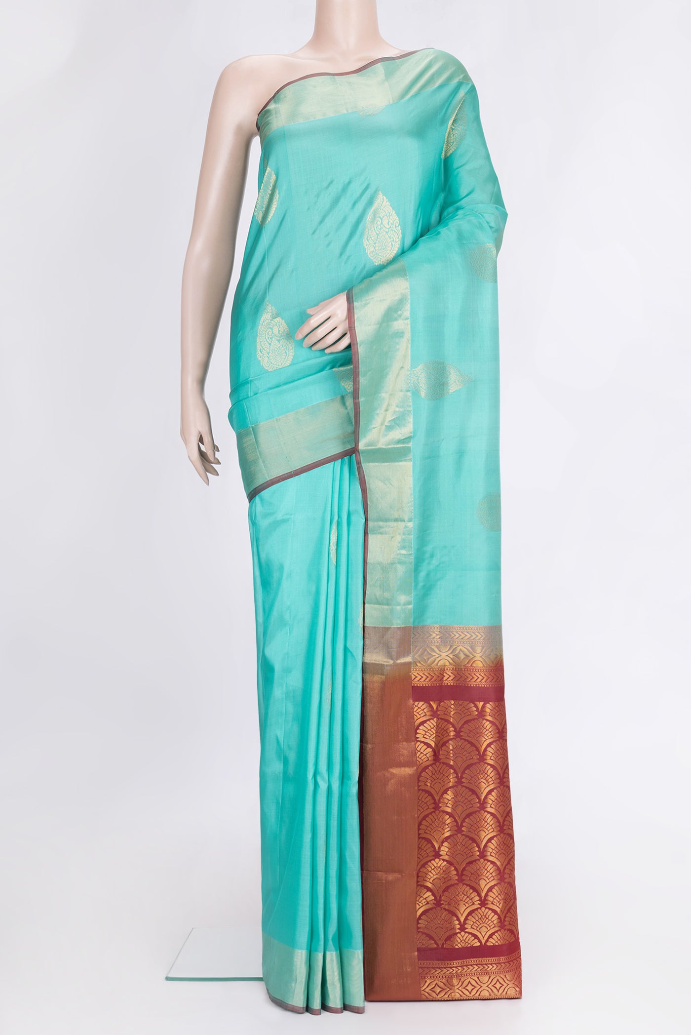 Sea Green Dual Tone Soft Silk Saree with Zari Butta on the body and Zari Border.  displayed on a mannequin