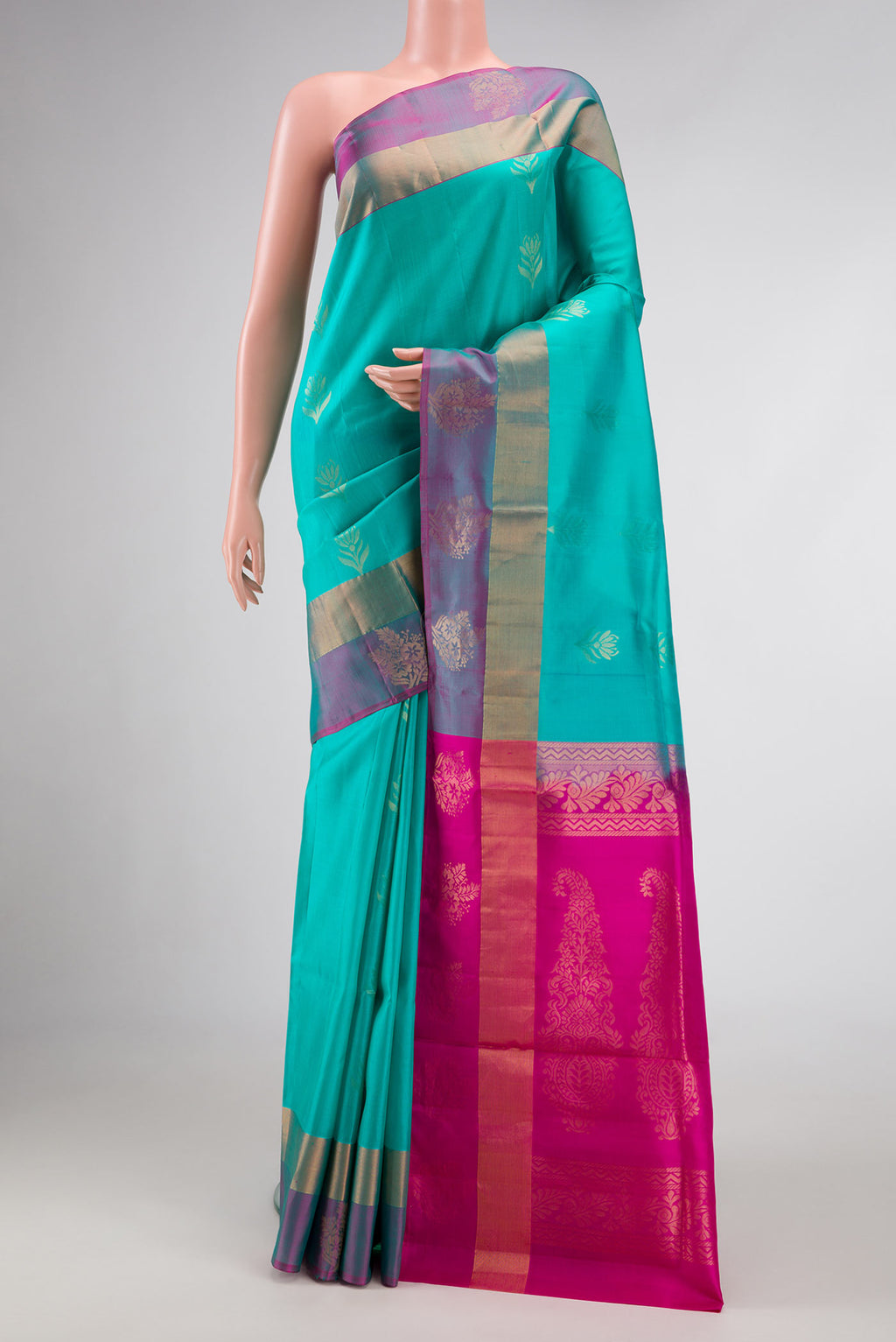 Sea Green Dual Tone Soft Silk Saree with Zari Butta on the body and Fancy Border.  displayed on a mannequin