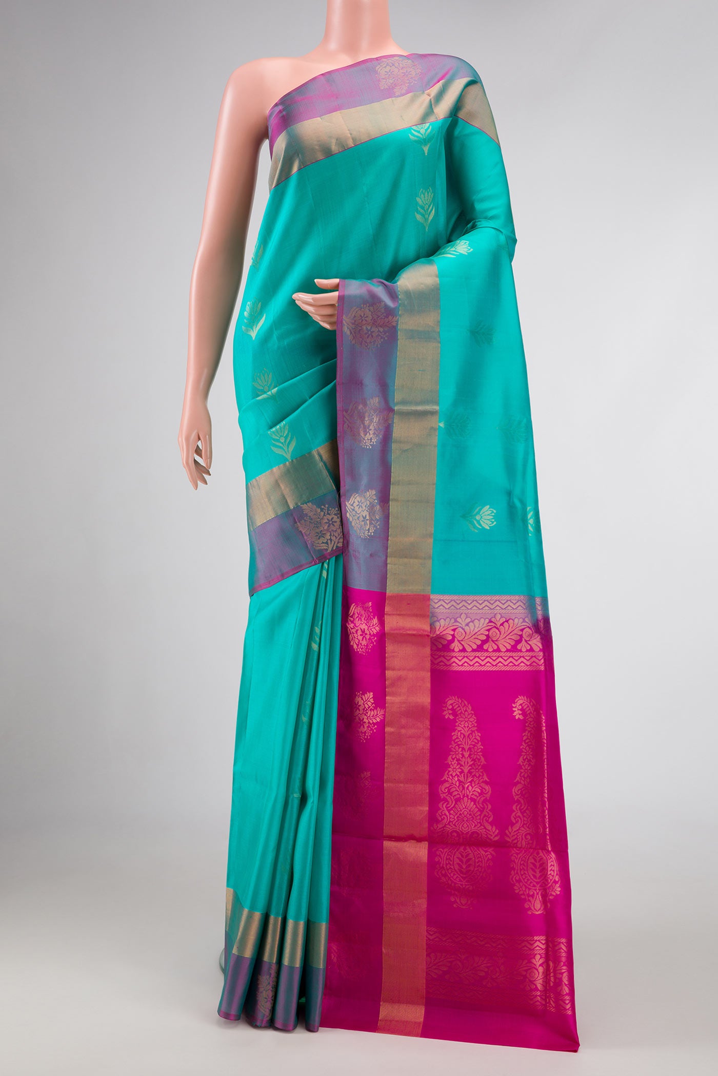 Sea Green Dual Tone Soft Silk Saree with Zari Butta on the body and Fancy Border.  displayed on a mannequin