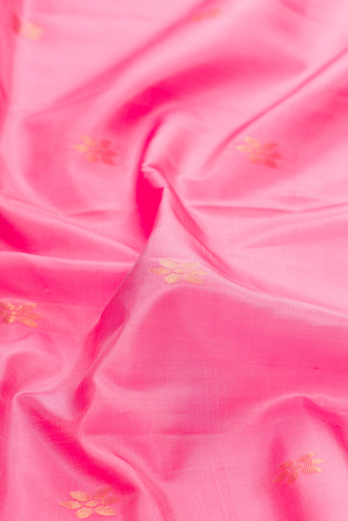 Close up of Pink Dual Tone Soft Silk Saree with Zari Butta on the body and Fancy Border.  displaying folds