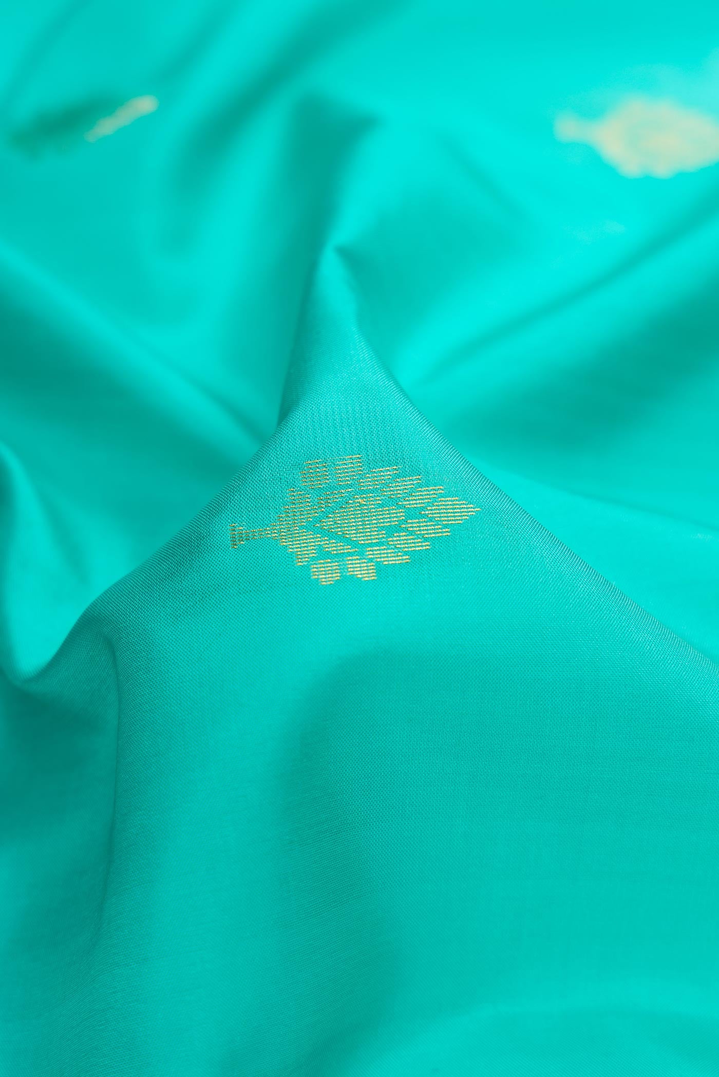 Close up of Sky Blue Dual Tone Soft Silk Saree with Zari Butta on the body and Zari Border.  displaying folds