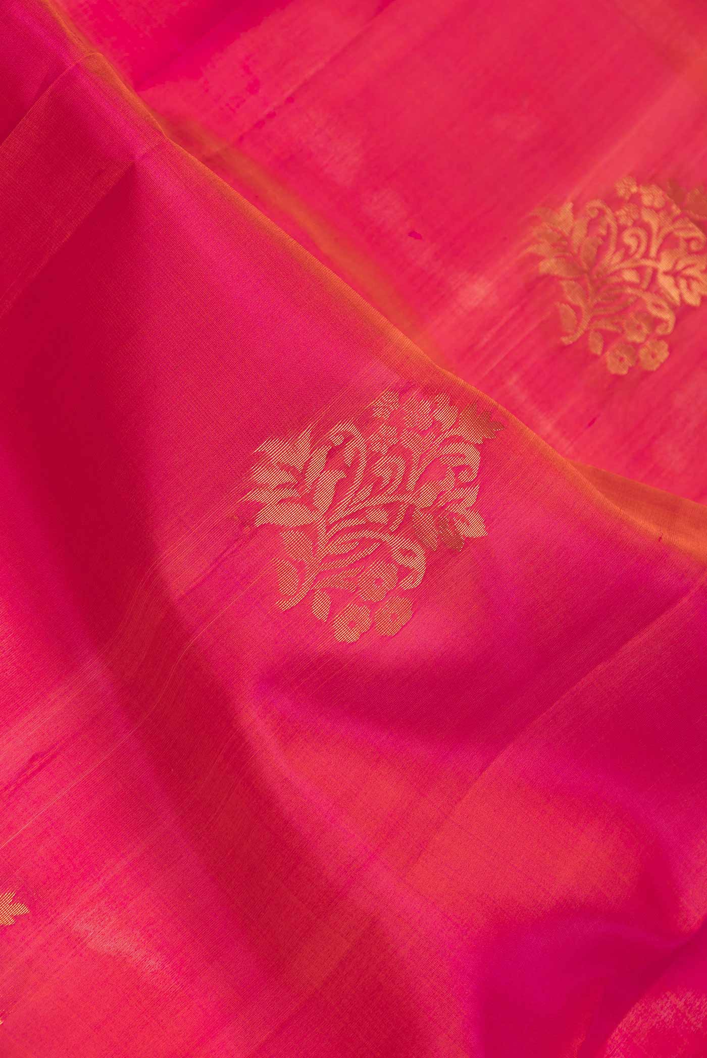 Close up of Dark Pink Dual Tone Soft Silk Saree with Zari Butta on the body and Zari Border.  displaying folds