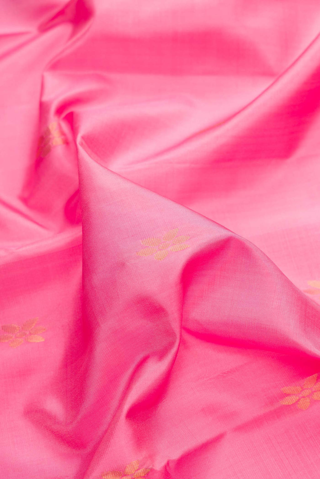 Close up of Pink Dual Tone Soft Silk Saree with Zari Butta on the body and Zari Border.  displaying folds