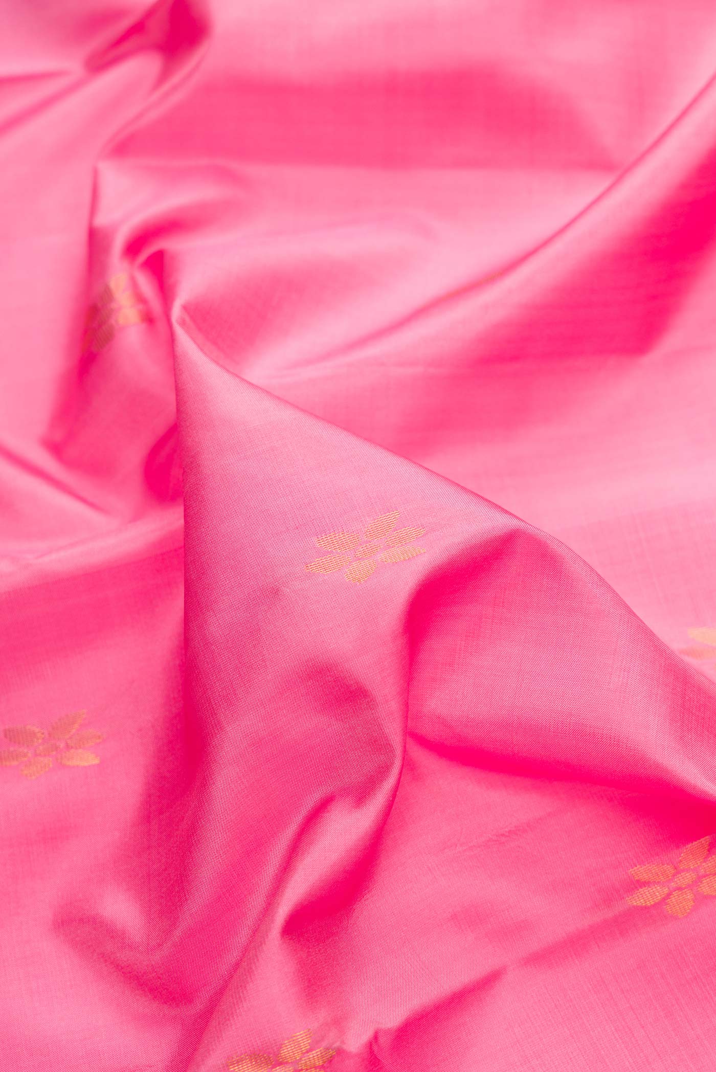 Close up of Pink Dual Tone Soft Silk Saree with Zari Butta on the body and Zari Border.  displaying folds