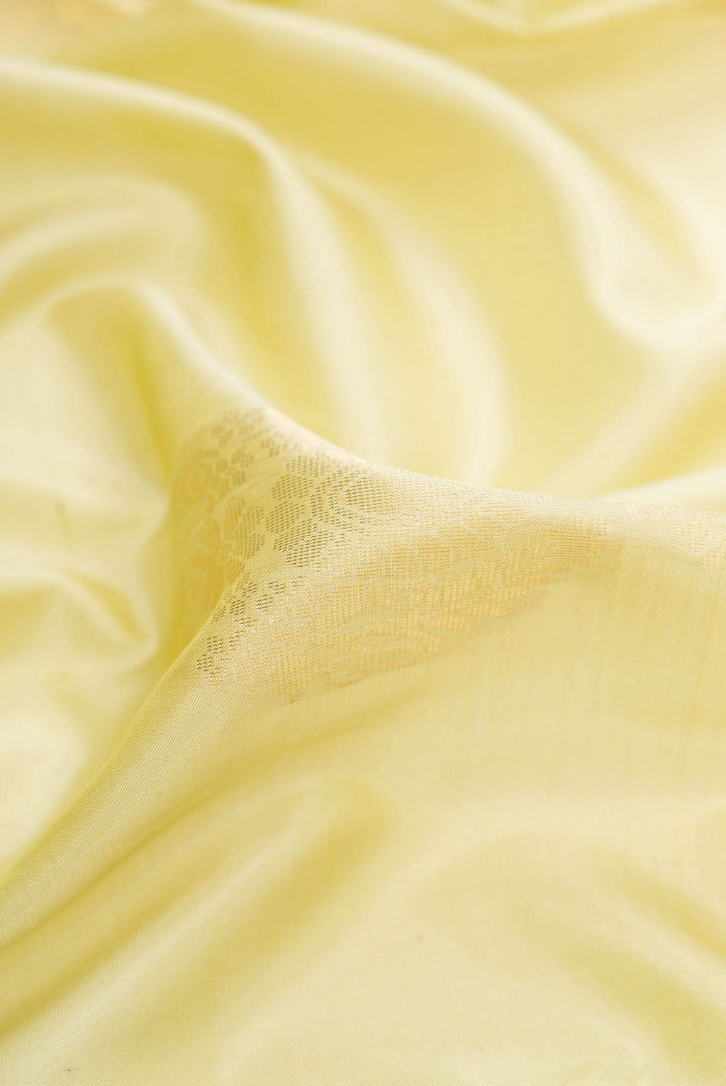 Close up of Pista Green Dual Tone Soft Silk Saree with Zari Butta on the body and Zari Border.  displaying folds