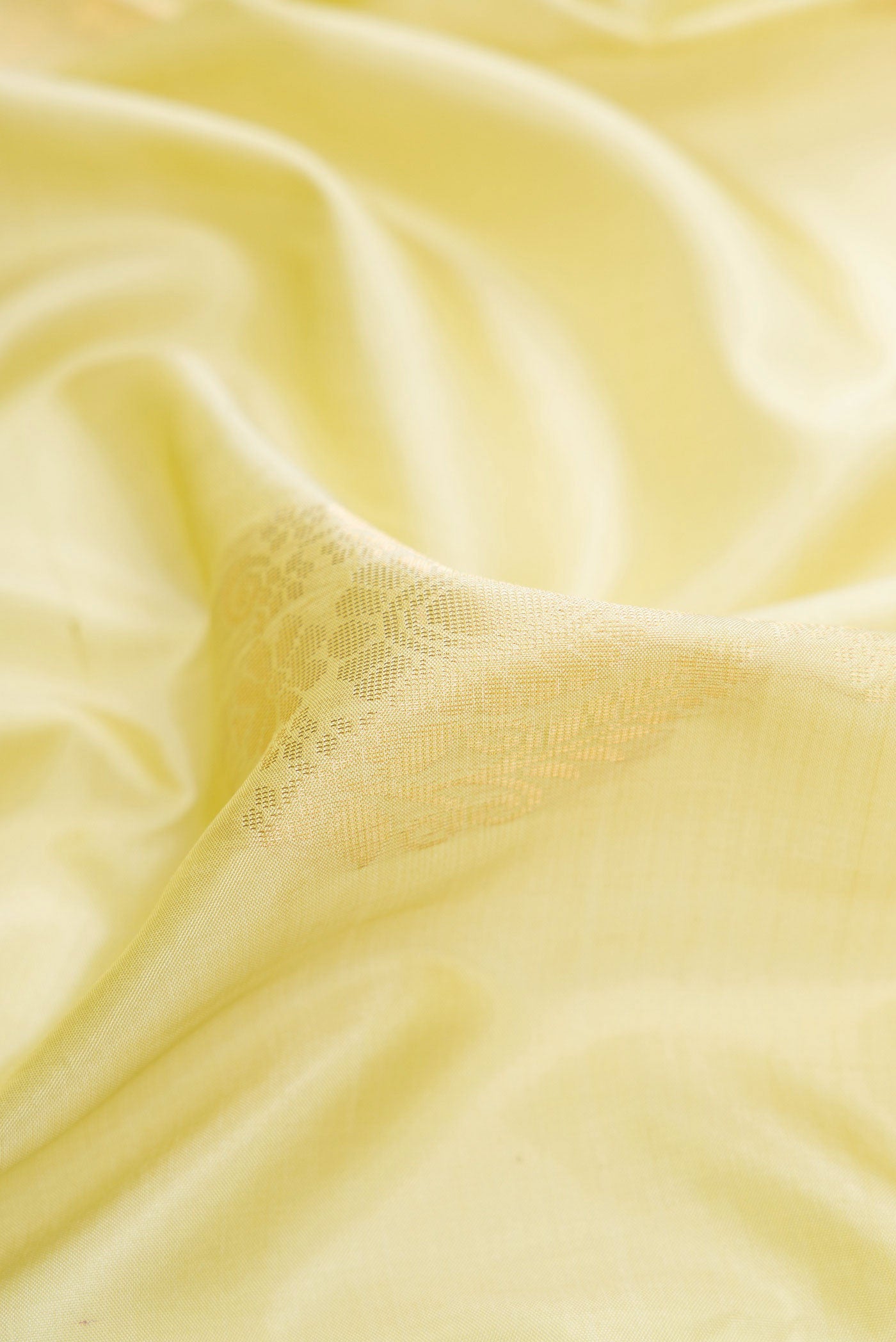 Close up of Pista Green Dual Tone Soft Silk Saree with Zari Butta on the body and Zari Border.  displaying folds