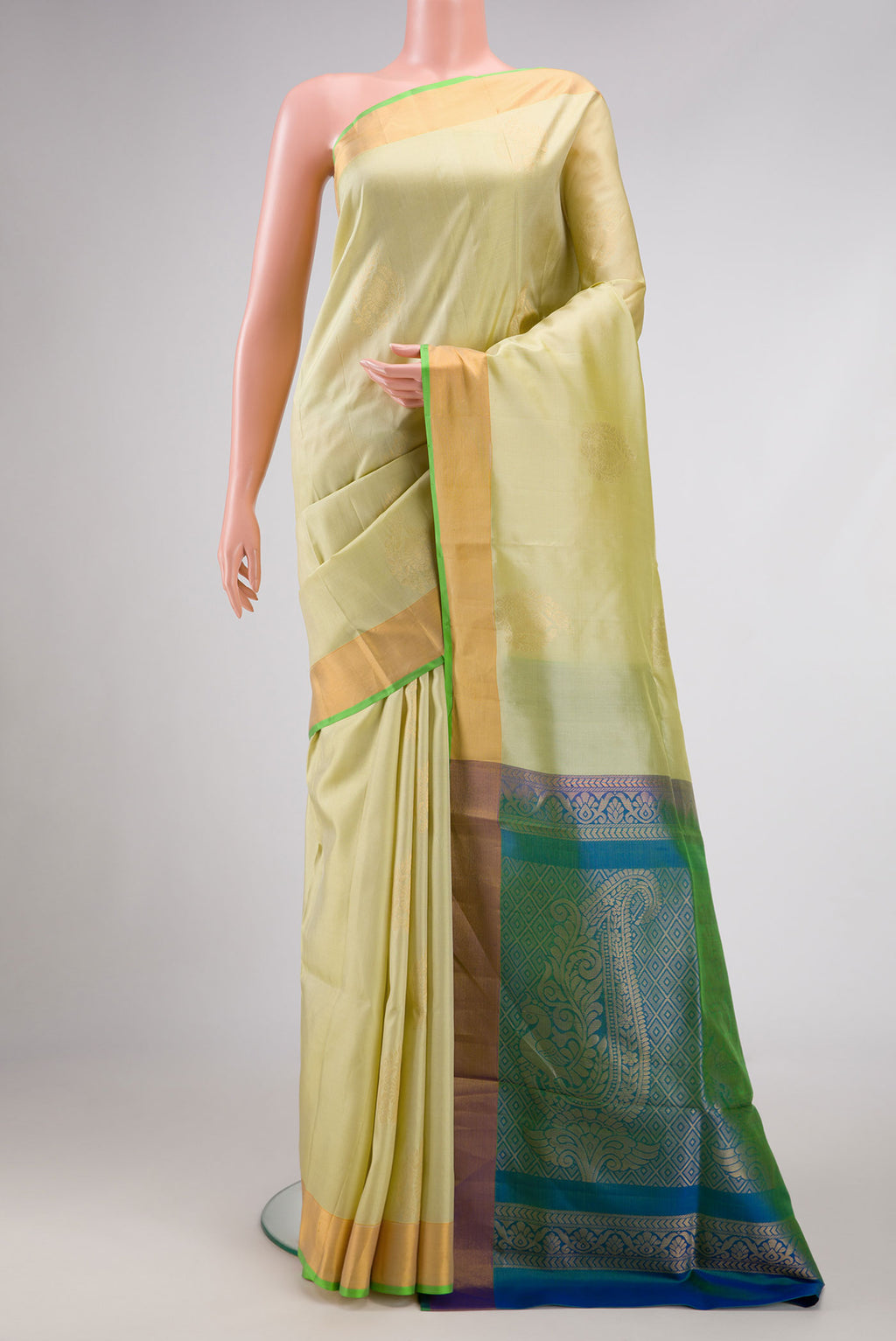Pista Green Dual Tone Soft Silk Saree with Zari Butta on the body and Zari Border.  displayed on a mannequin
