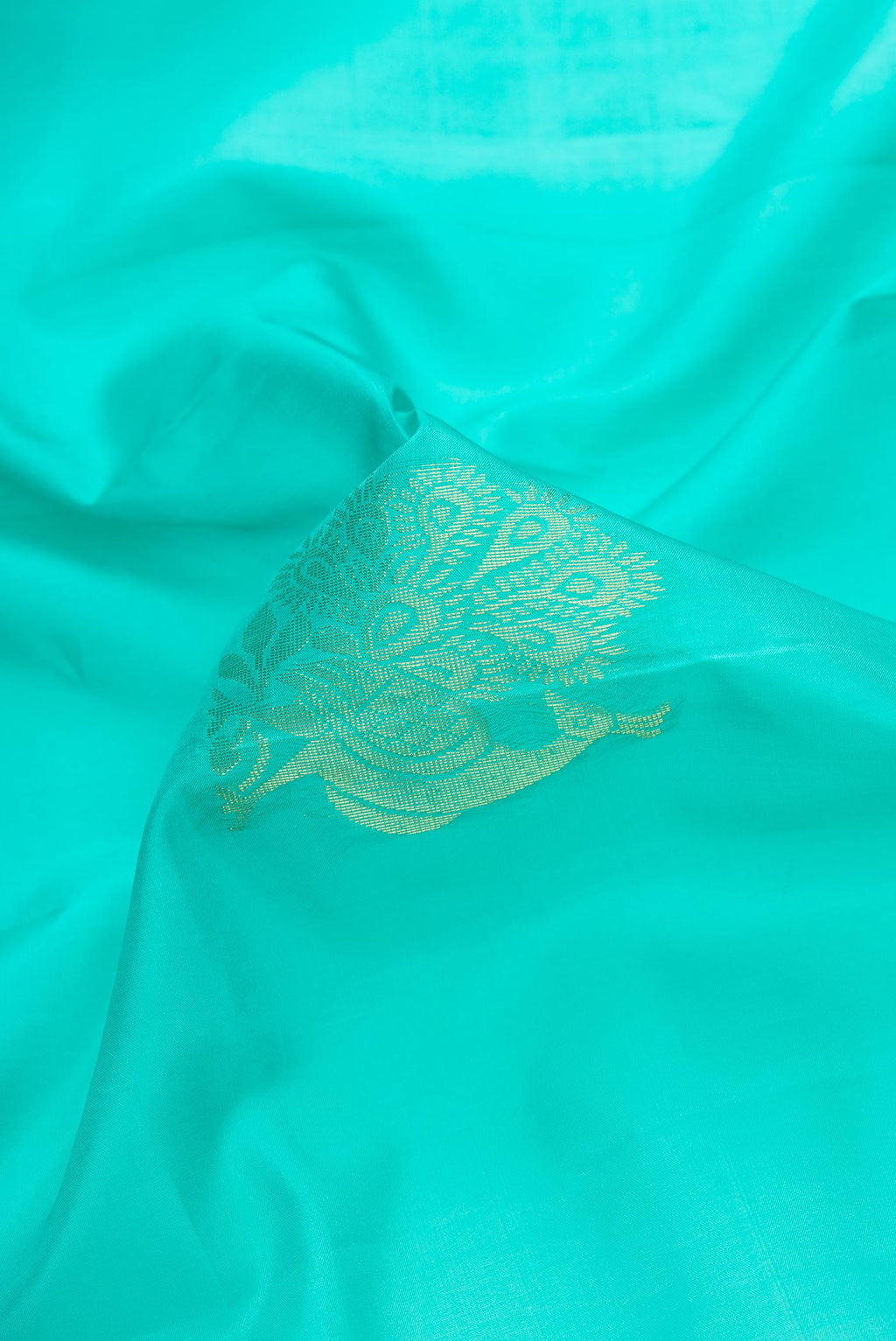 Close up of Sky Blue Dual Tone Soft Silk Saree with Zari Butta on the body and Zari Border.  displaying folds
