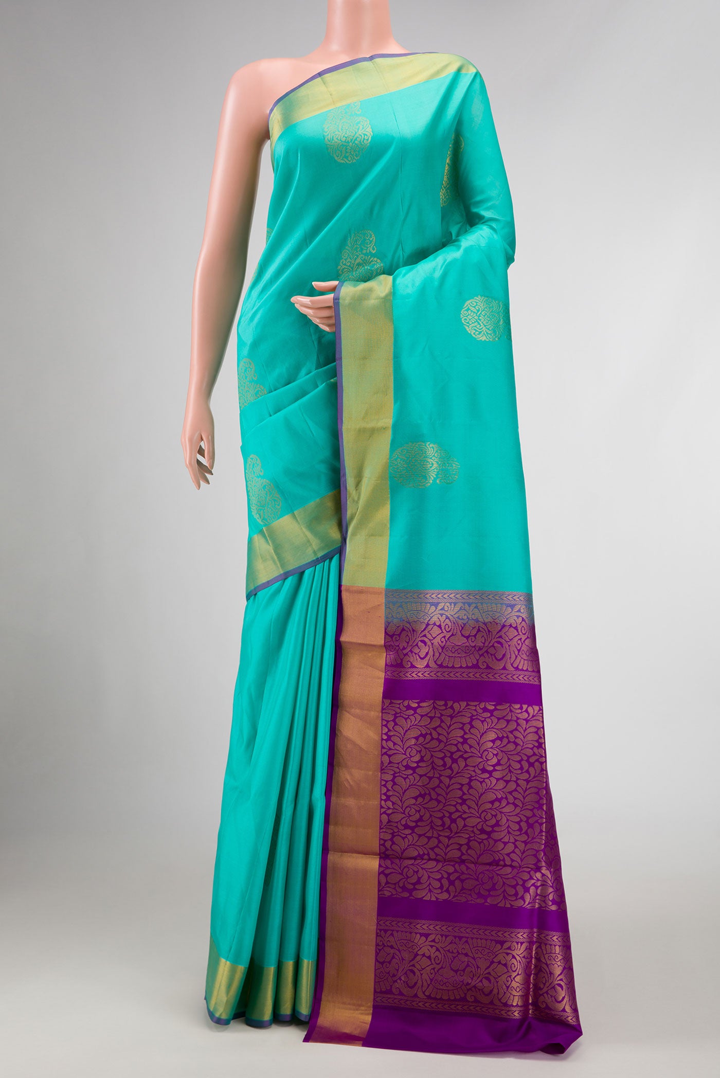 Sea Green Dual Tone Soft Silk Saree with Zari Butta on the body and Zari Border.  displayed on a mannequin
