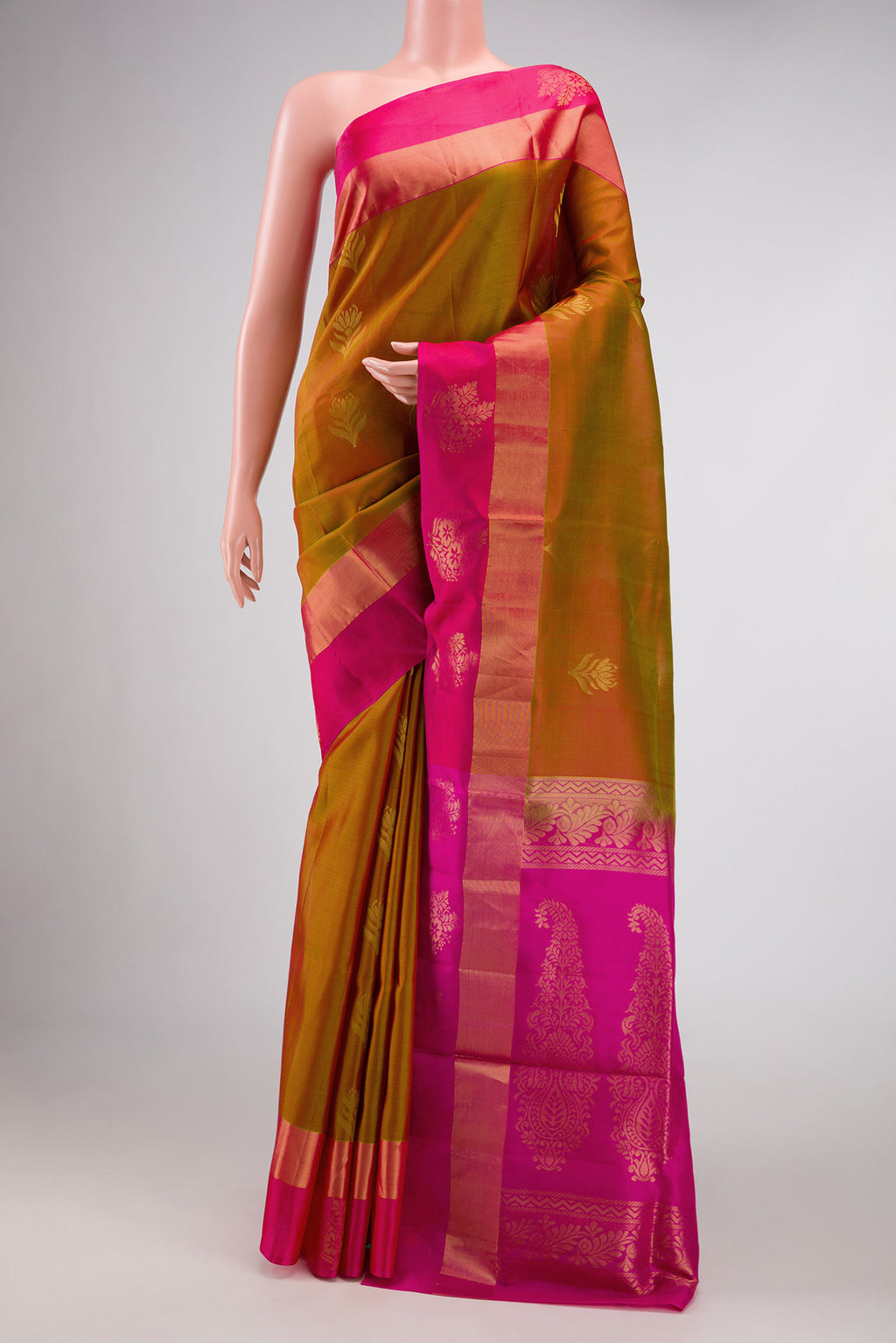 Mehandi Green Dual Tone Soft Silk Saree with Zari Butta on the body and Fancy Border.  displayed on a mannequin
