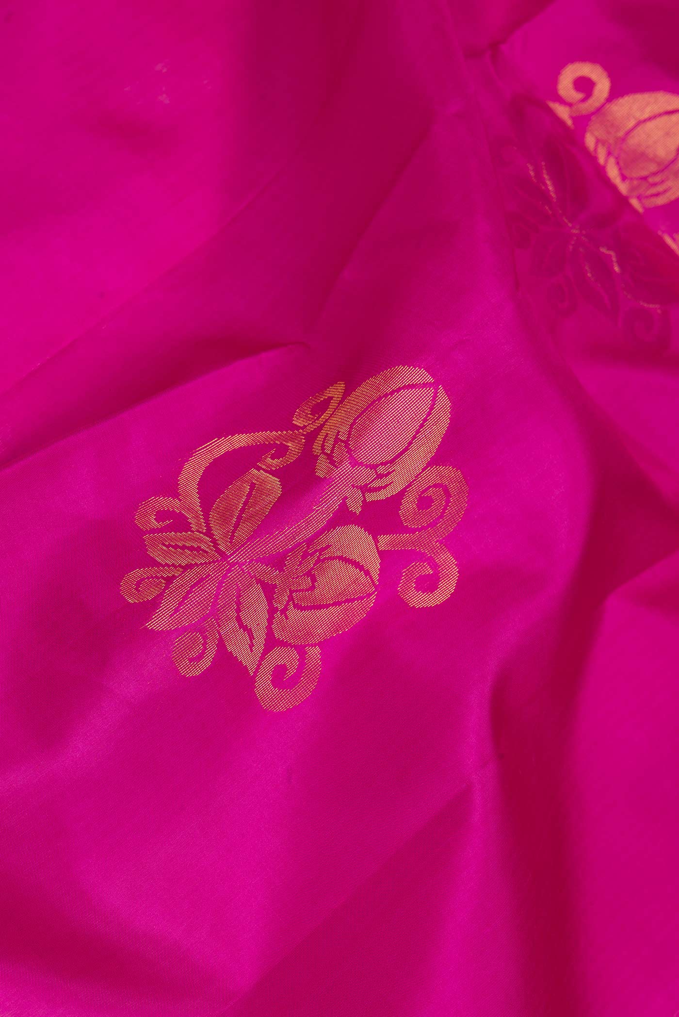 Close up of Pink Dual Tone Soft Silk Saree with Zari Butta on the body and Zari Border.  displaying folds