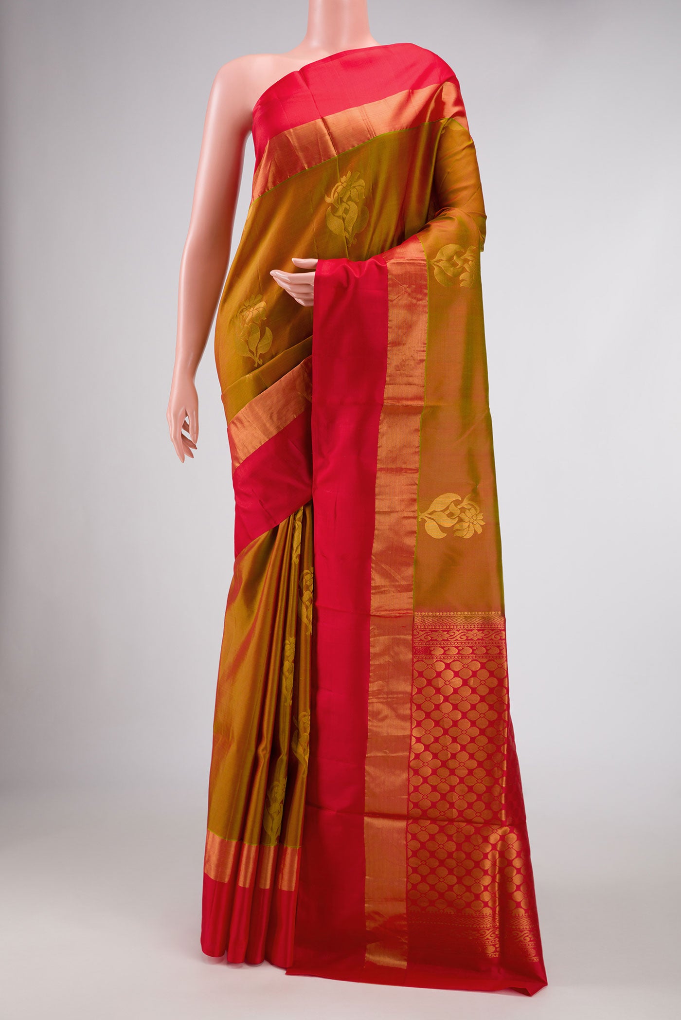 Mehandi Green Dual Tone Soft Silk Saree with Zari Butta on the body and Zari Border.  displayed on a mannequin