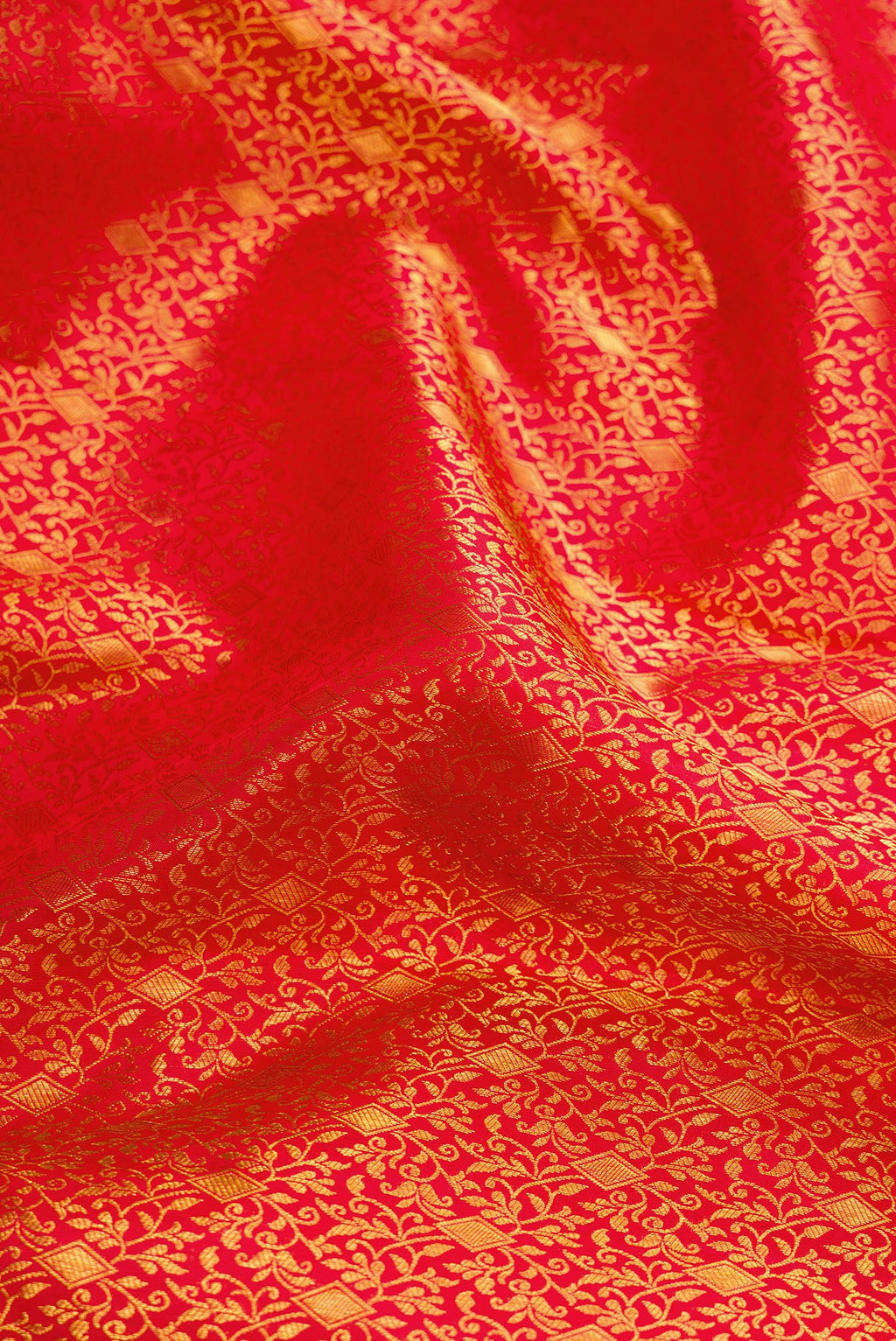 Close up of Red Dual Tone Kanjivaram Silk Saree with Zari Brocade on the body and Zari Border.  displaying folds