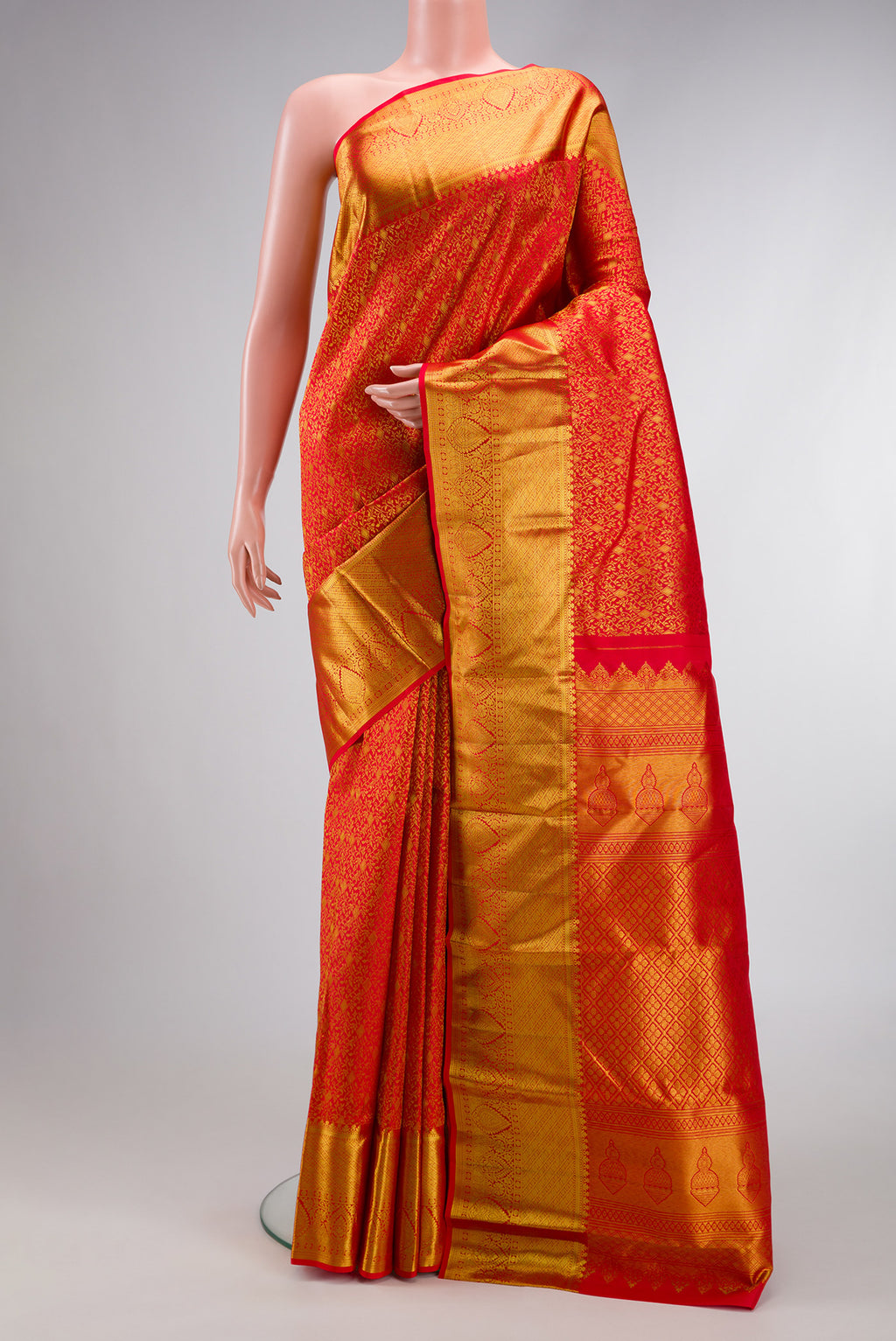 Red Dual Tone Kanjivaram Silk Saree with Zari Brocade on the body and Zari Border.  displayed on a mannequin