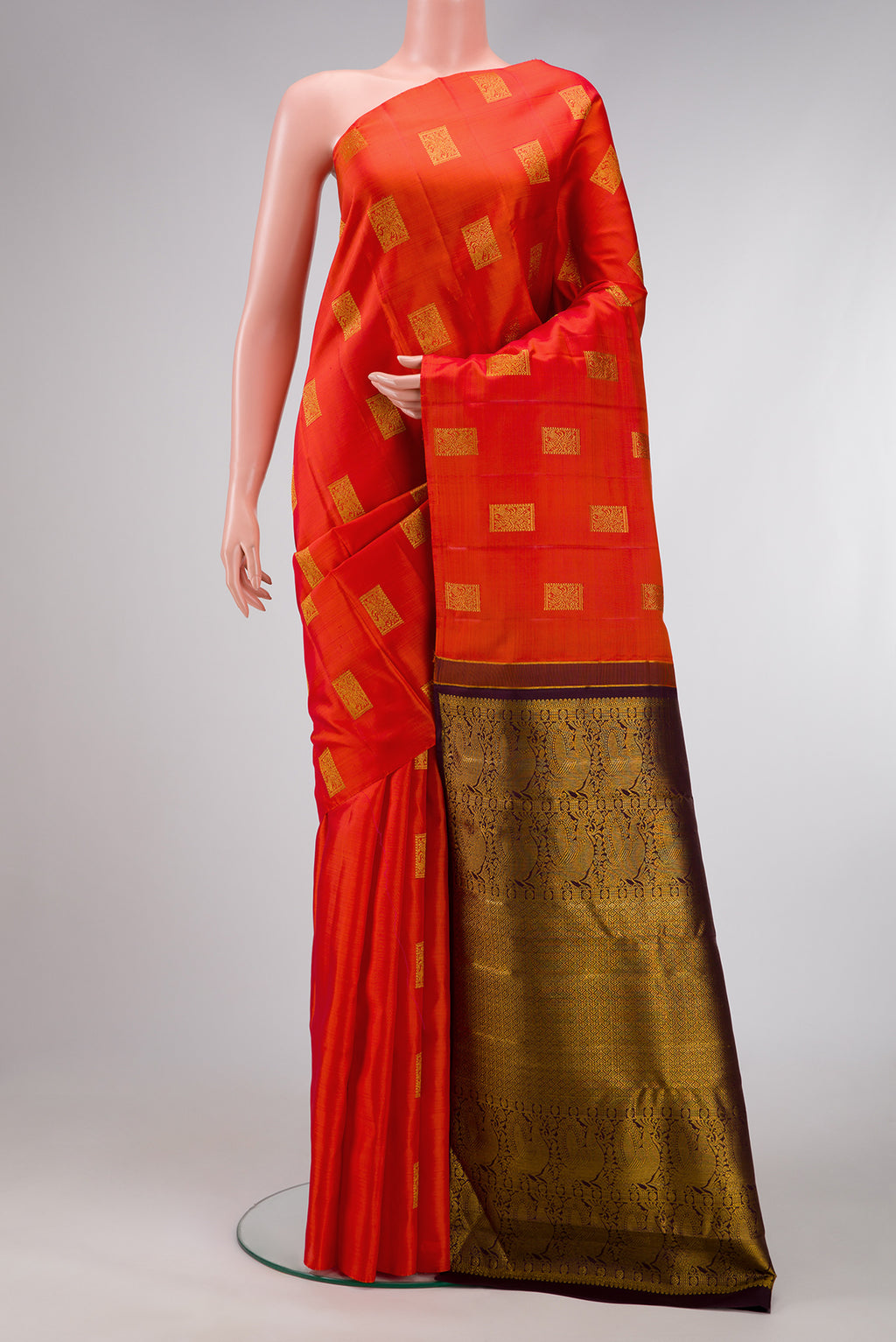 Orange Dual Tone Kanchipuram Silk Saree with Zari Butta on the body and Without Border.  displayed on a mannequin
