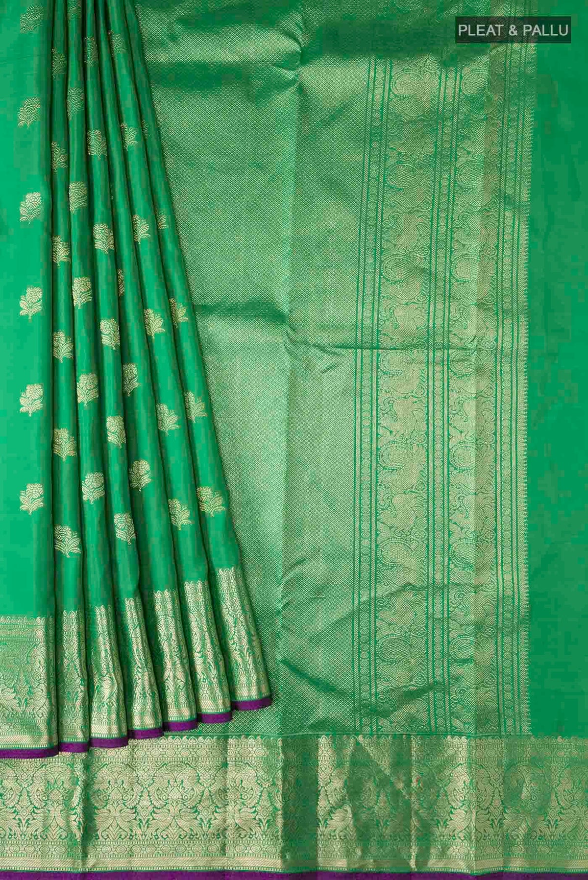 Pleats and pallu of Green Kanchipuram Silk Saree with Zari Butta on the body and Zari Border