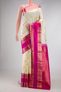 Off White Dual Tone Kanchipuram Silk Saree with Zari Butta on the body and Zari Border.  displayed on a mannequin