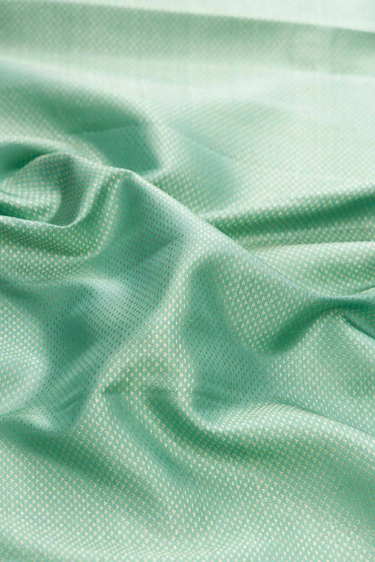 Close up of Light Blue Kanchipuram Silk Saree with Zari Brocade on the body and Zari Border displaying folds